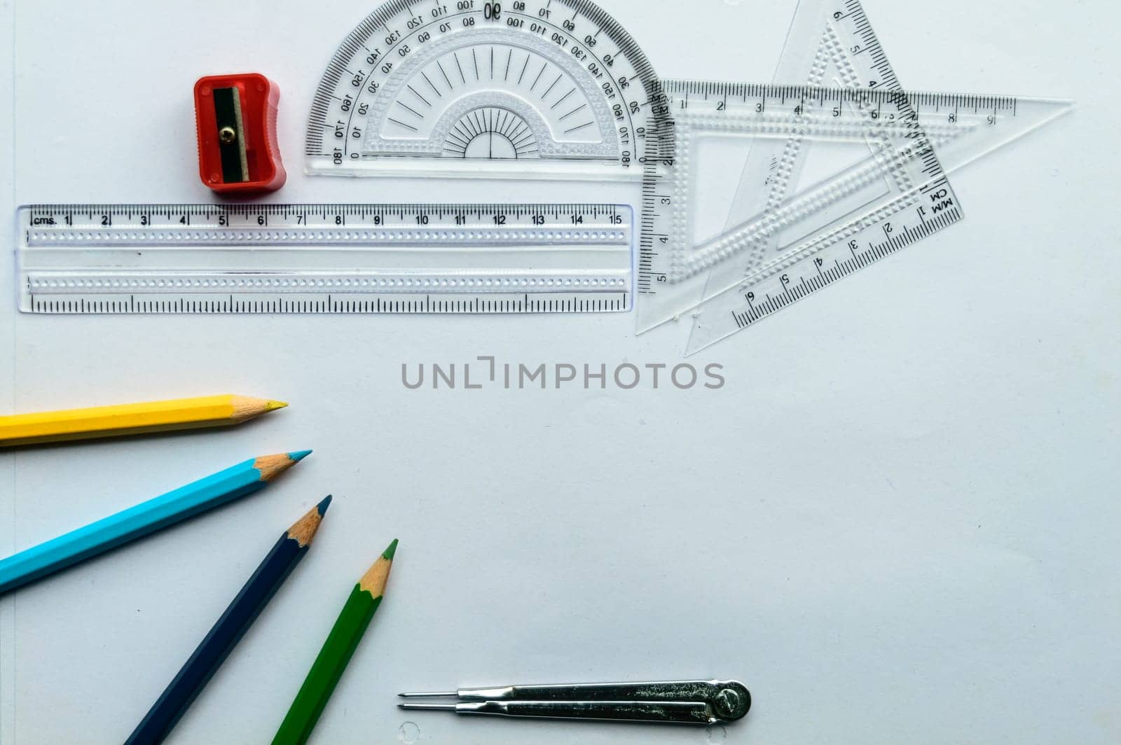 Geometric Measuring tools, Drawing items and mathematical instruments placed on white paper sheet. Back to school and Engineering education learning background. Empty Copy space room for text.