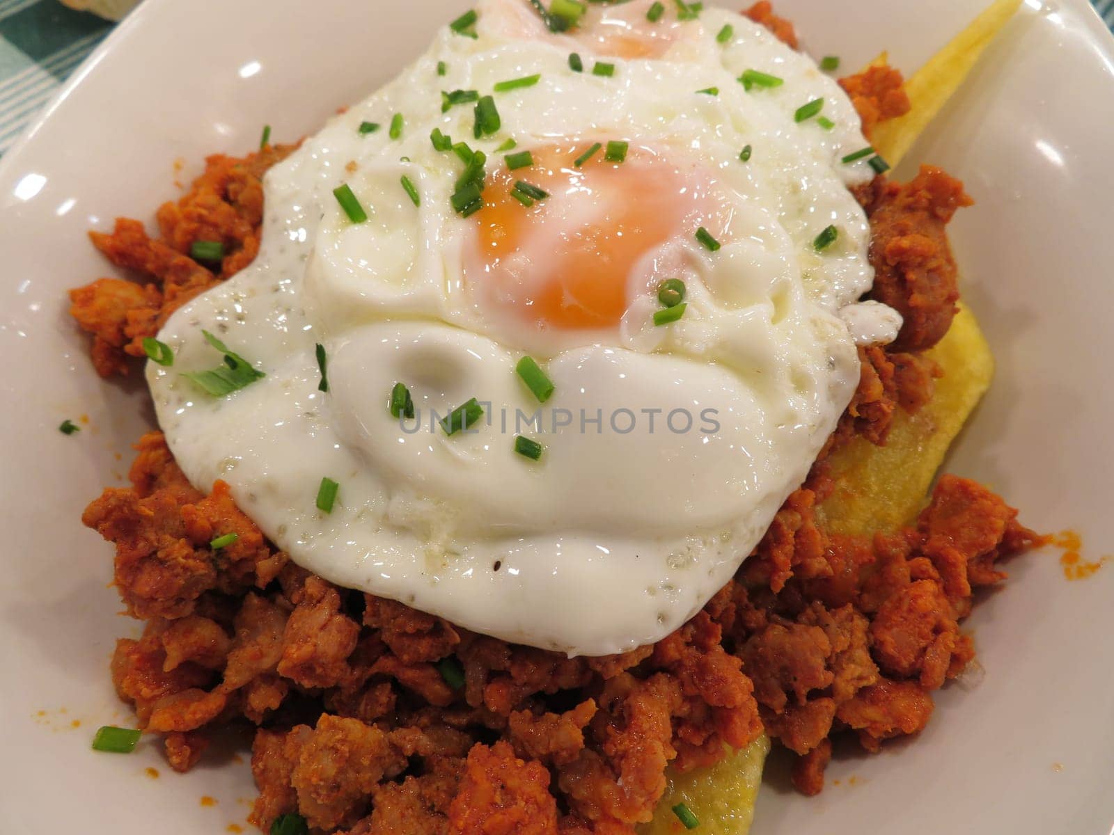 delicious fried eggs with mincemeat meat chips
