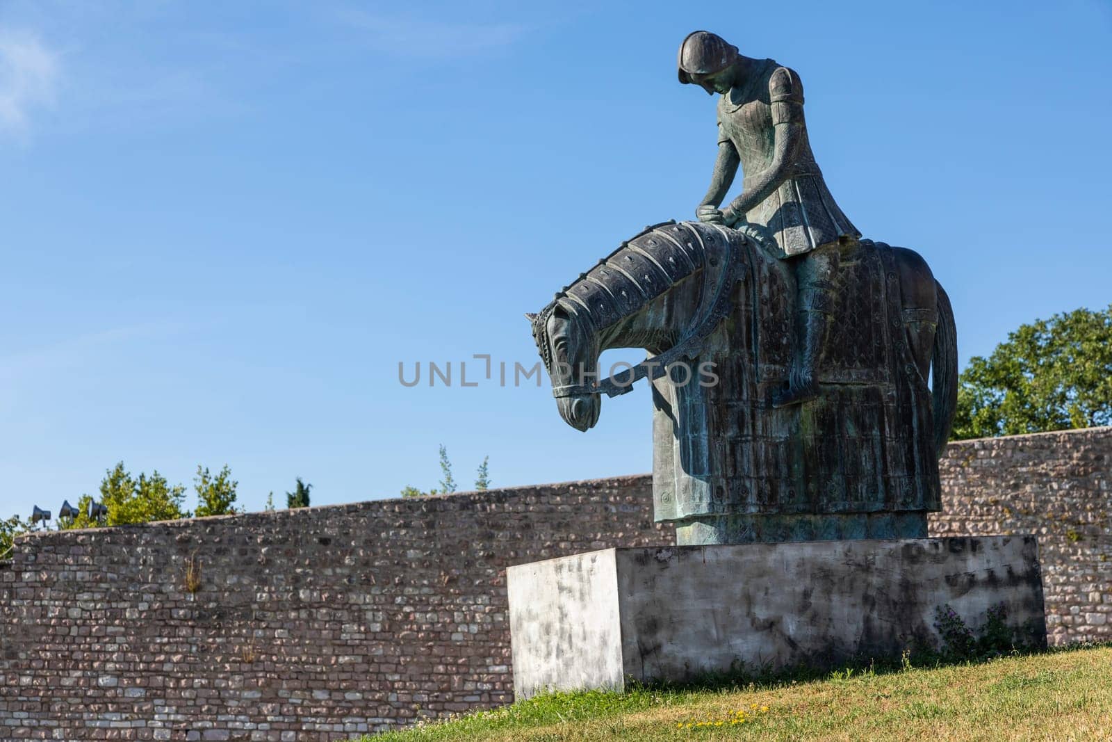 Assisi village in Umbria region, Italy. Statue of St. Francis. The town is famous for the most important Italian St. Francis Basilica (Basilica di San Francesco)