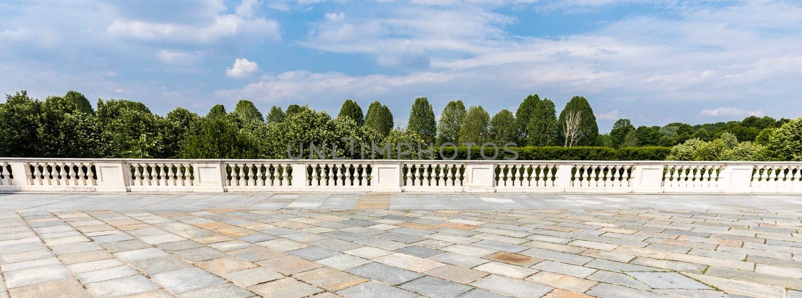 Exterior with old grey floor made of stone. Vintage textured pavement and blue sky in the background.