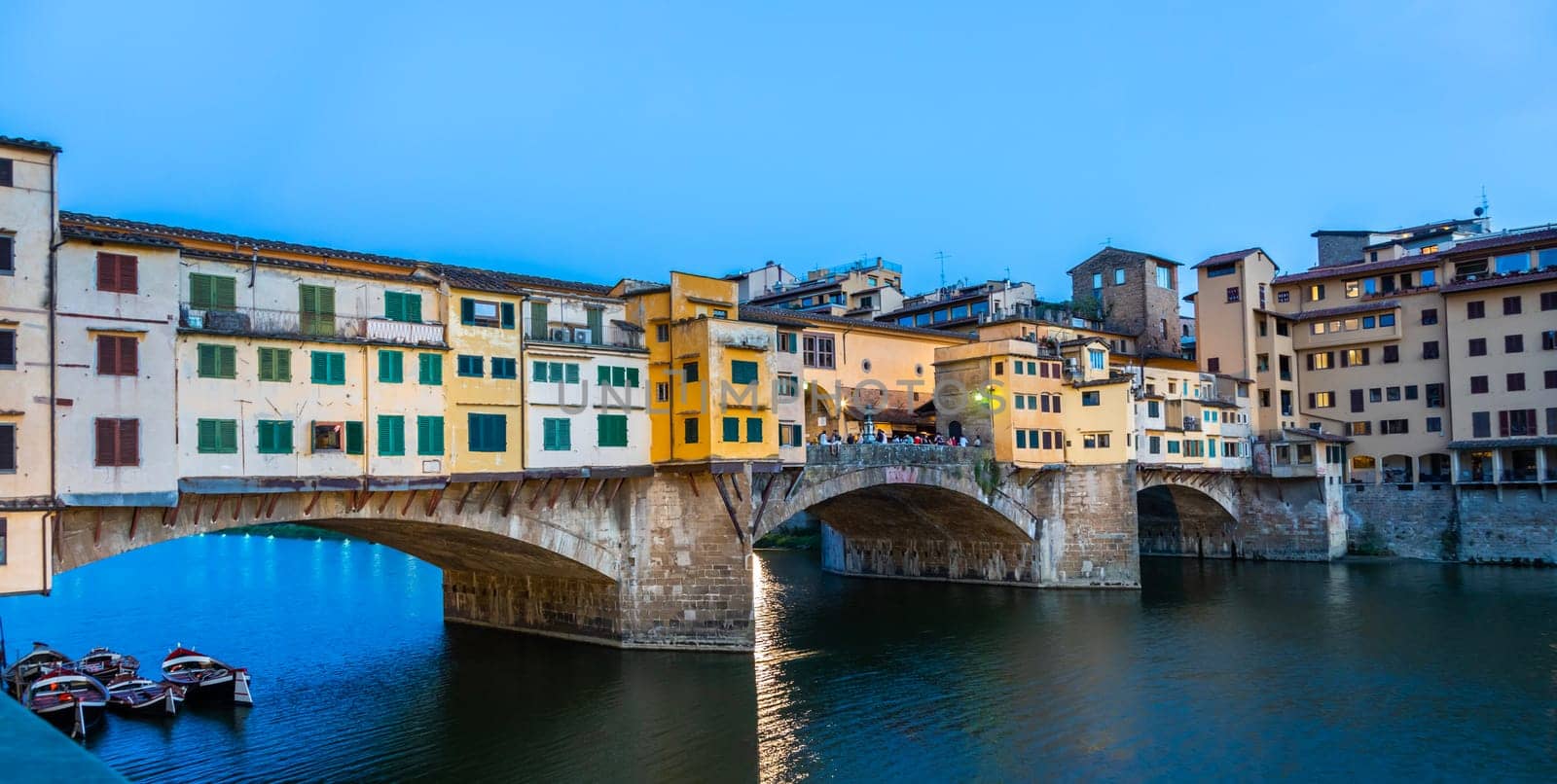 Florence, Italy - Circa June 2021: sunset on Ponte Vecchio - Old Bridge. Amazing blue light before the evening.
