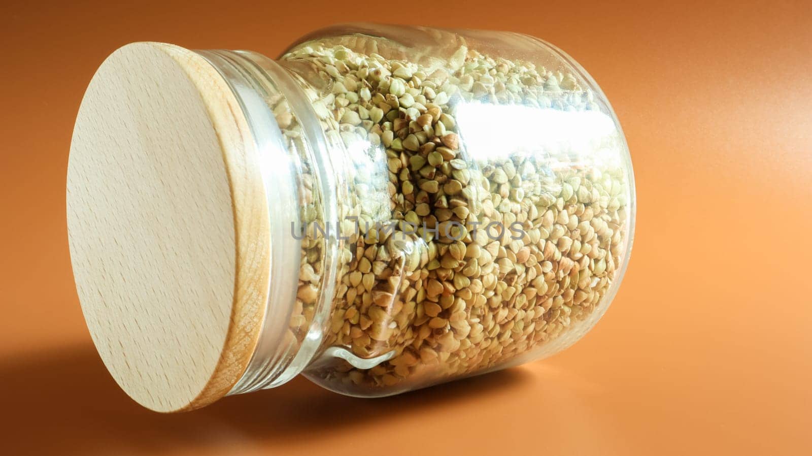 Green sprouts of raw organic buckwheat in a glass jar for cereals. Vegan food concept. Organic food. The concept of diet, weight loss, healthy and proper nutrition. Copy space for text