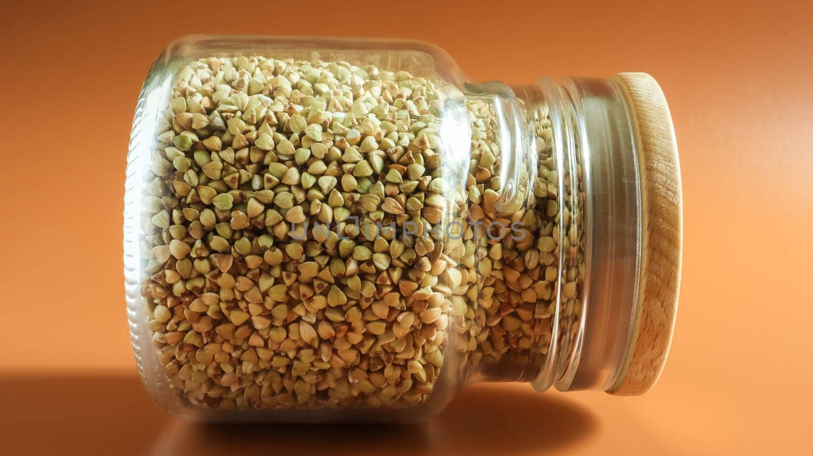 Green sprouts of raw organic buckwheat in a glass jar for cereals. Vegan food concept. Organic food. The concept of diet, weight loss, healthy and proper nutrition. Copy space for text