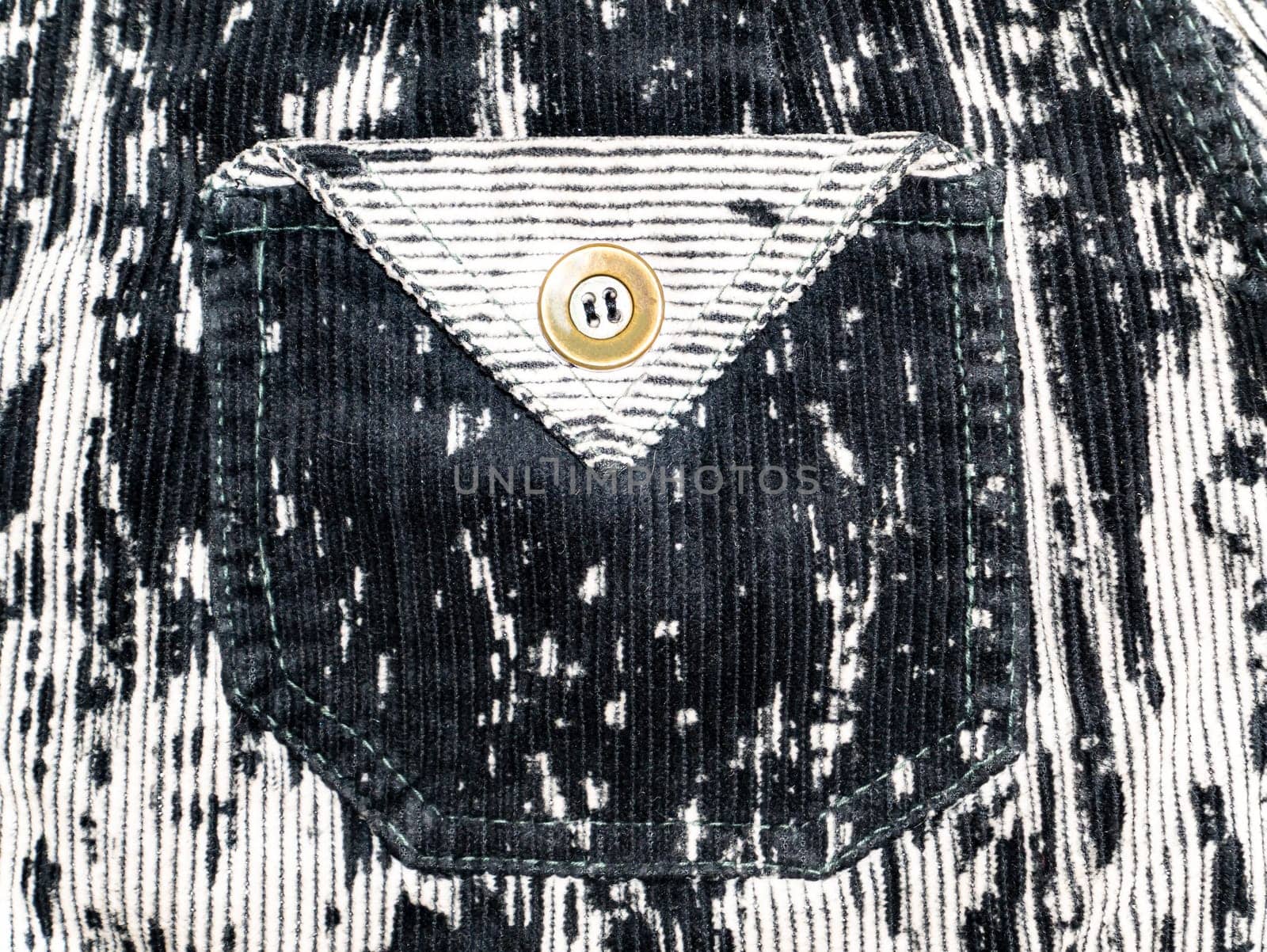 Pocket with button on velvet fabric. Background image. Place for text.