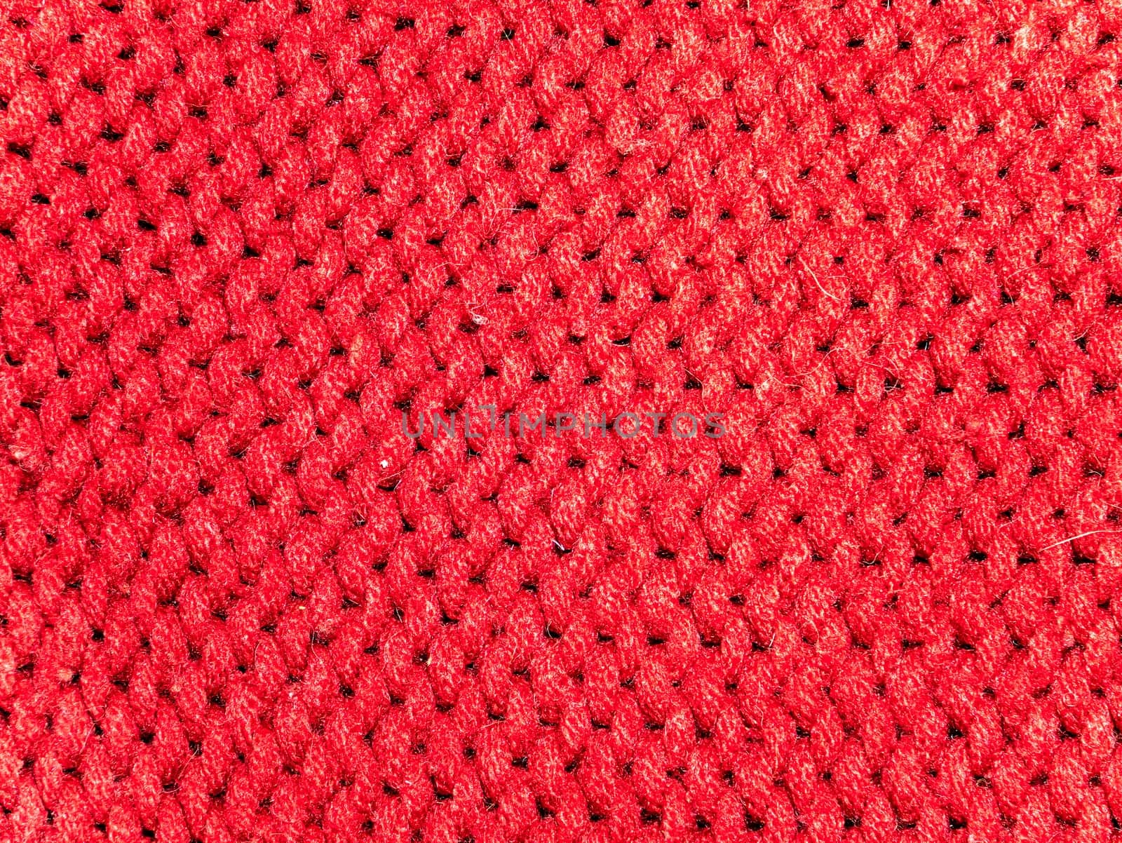 Texture of red woolen knitted fabric. Background image. Place for text.