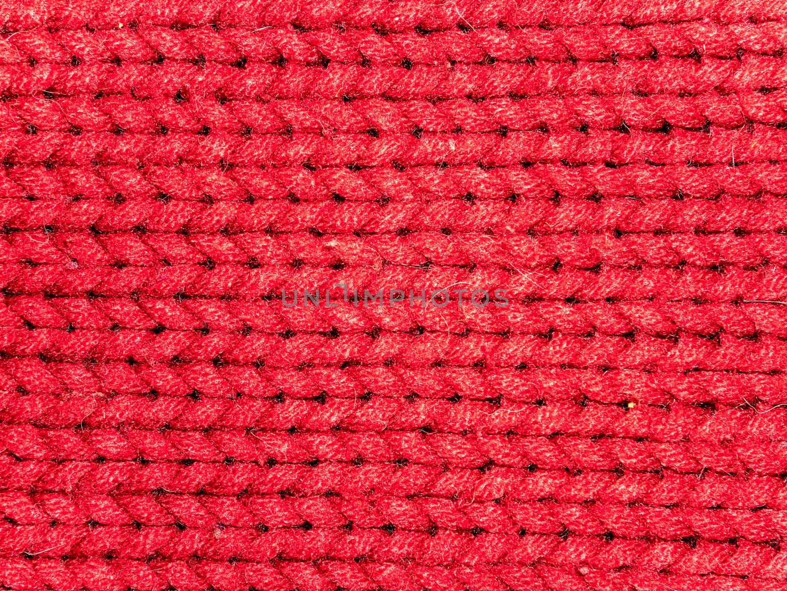 Texture of red woolen knitted fabric. Background image. Place for text.