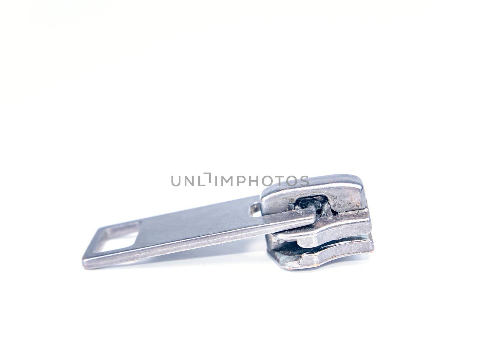 Zipper slider on a white background. Place for text. Free place. Macro photo.