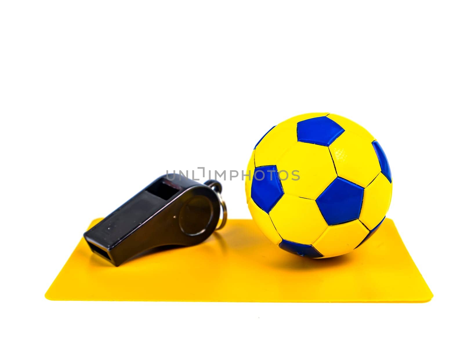 Soccer ball and yellow card with the whistle of a soccer referee on a white background. Football. Championship. World. Europe. Referee. Place for text.