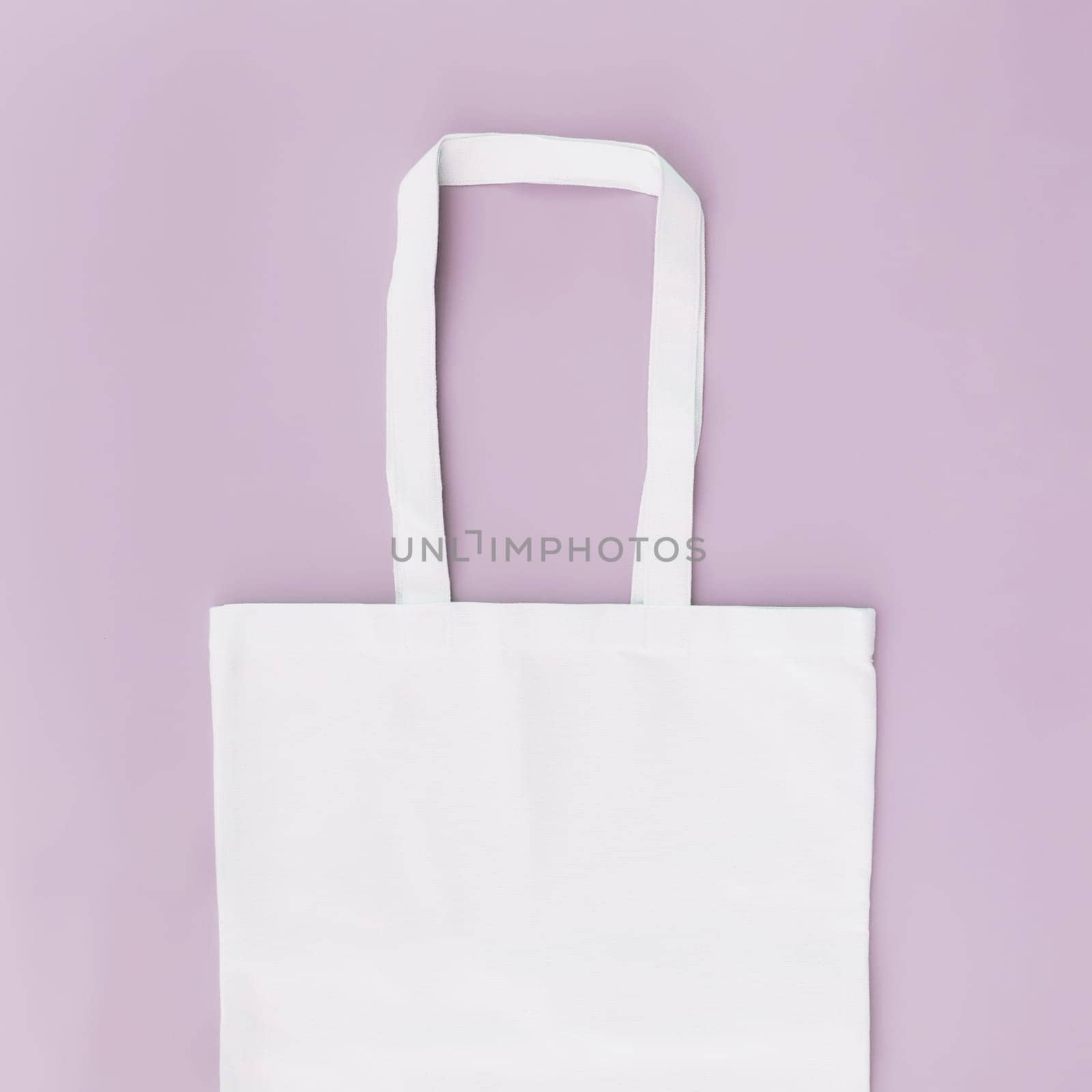 Eco white craft paper bag flat lay on pink background with copy space empty advertising area. Packaging template mock up. Delivery service, reusable and recyclable resources concept