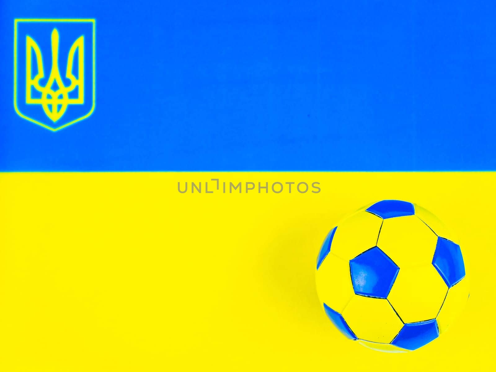 Soccer ball on the background of the national flag of Ukraine. Place for text. Football championship. Europe. World. National team.