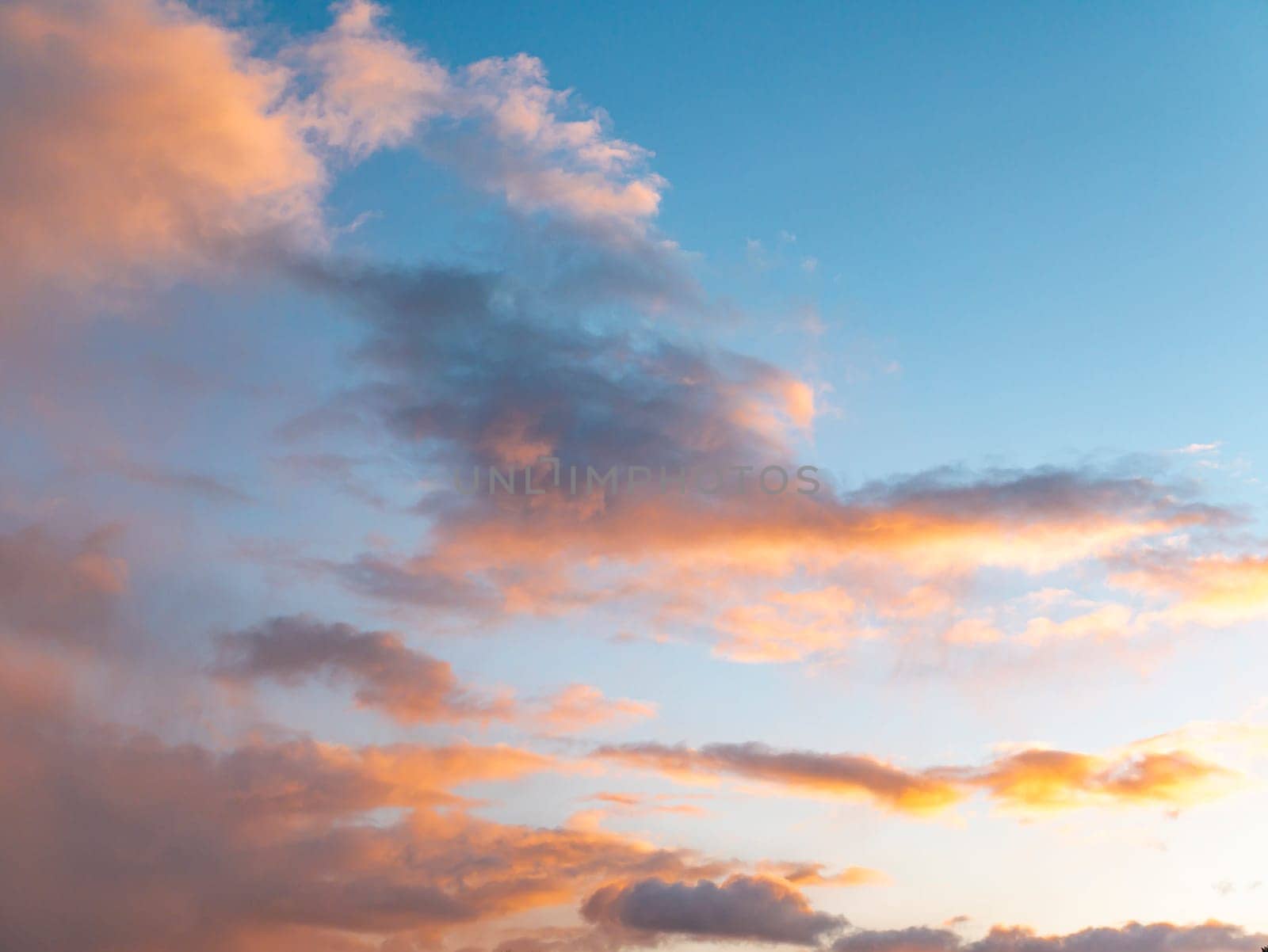 Cloudy landscape in the rays of sunny sunset. Nature. Scenery. Background image.