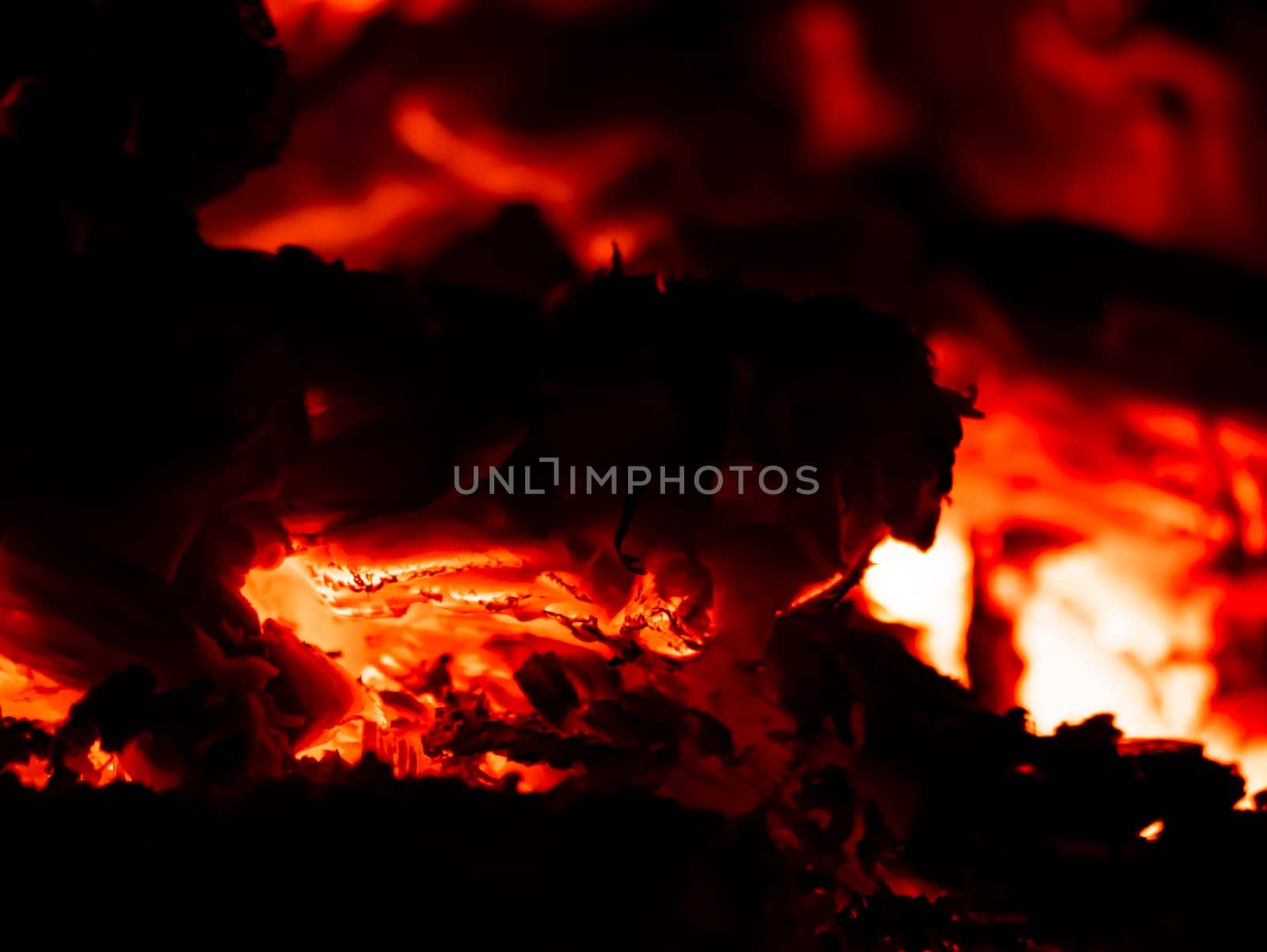 Red heat of charcoal burning wood in the dark. Fire. Background image. Place for text.