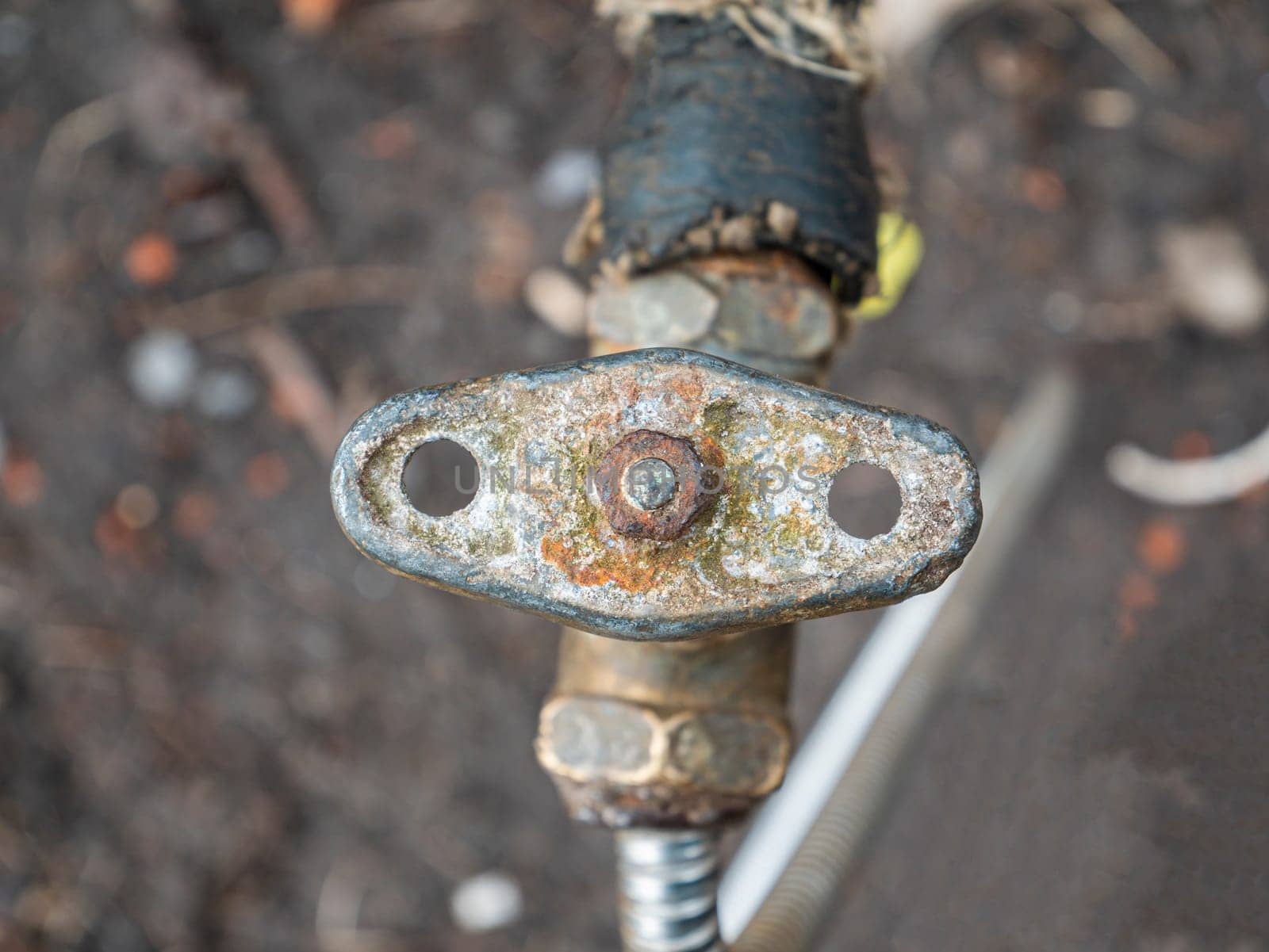 Old plumbing water tap with a metal valve. Equipment. Plumbing work. Water pipe repair. Plumber. Place for text. Background image.