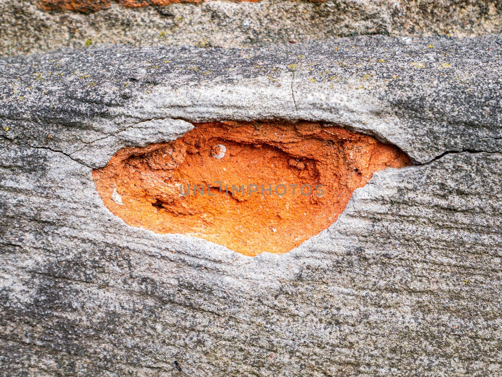 Chipped cement fragment of a red brick wall. Texture. Background image. Place for text. Building sector. Template for text. Poster.