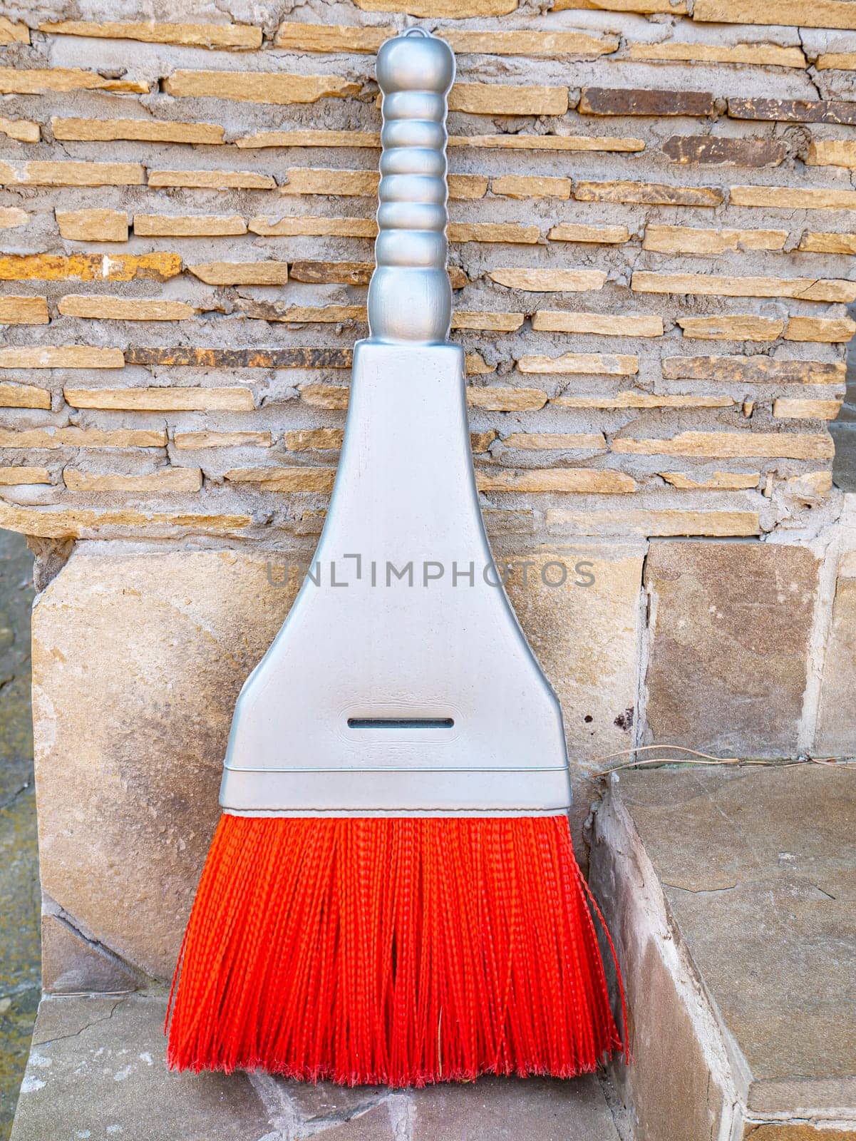 Plastic household broom for cleaning garbage from the floor. Tool. Home life. Background image. Place for text.
