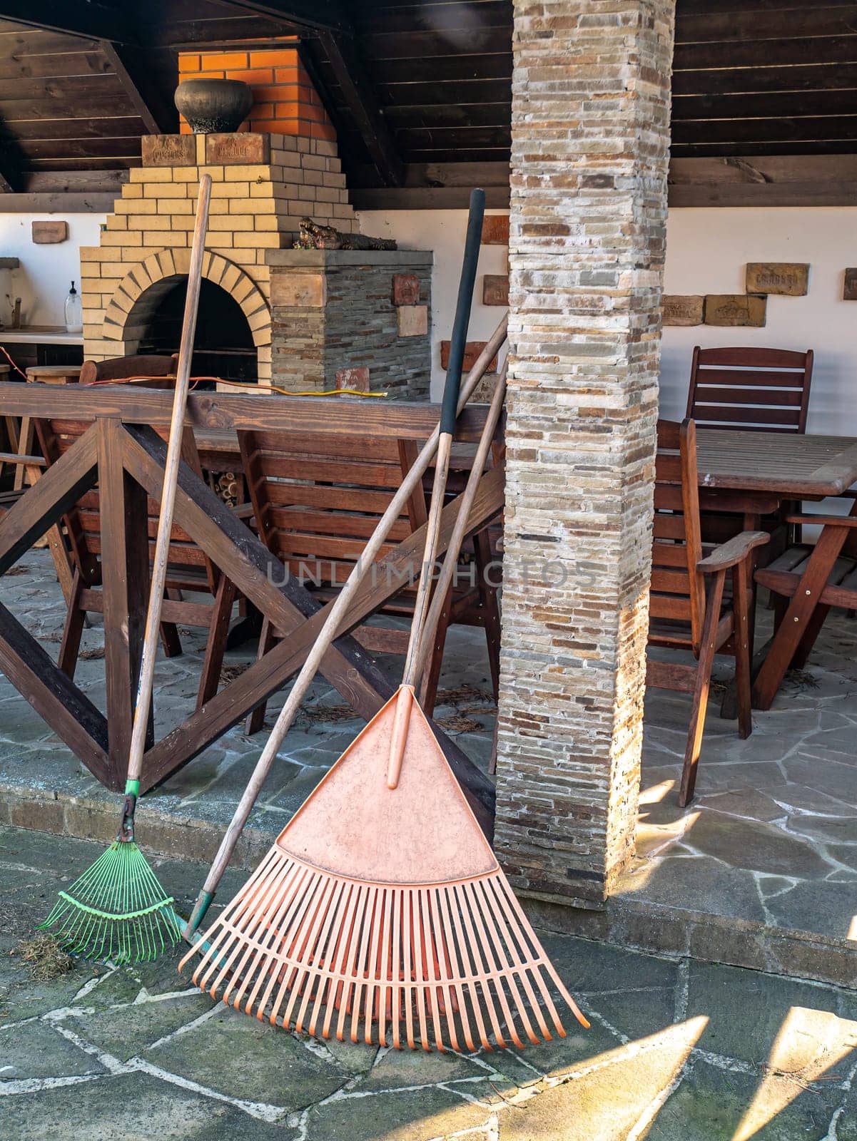 Garden tools fan and rake for cleaning leaves. Garden tools. Place for text. Background image. Cleaning the area.