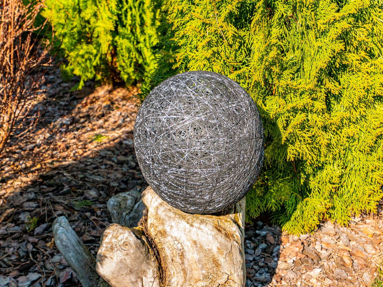 Balls of thread on a green flowerbed of a public park. Decor flower beds. Background image. Place for text. Hand mei. Handwork. Decoration.