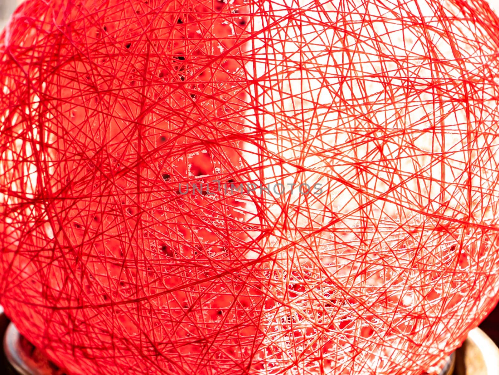 Red thread texture in sunlight from the window. Abstraction. Place for text. Background image.