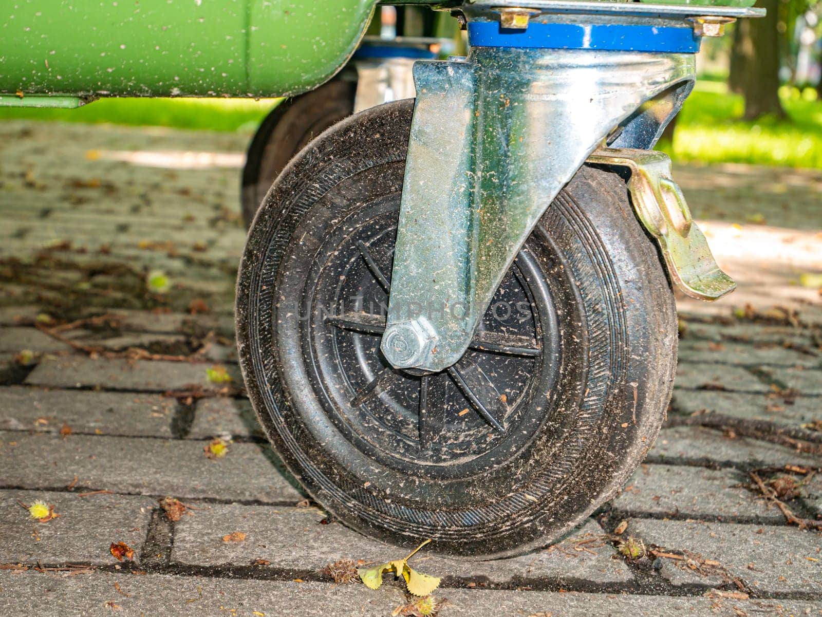 Black rubber wheel of a hand truck. Background image. Place for text. Poster. Abstraction. Roll.