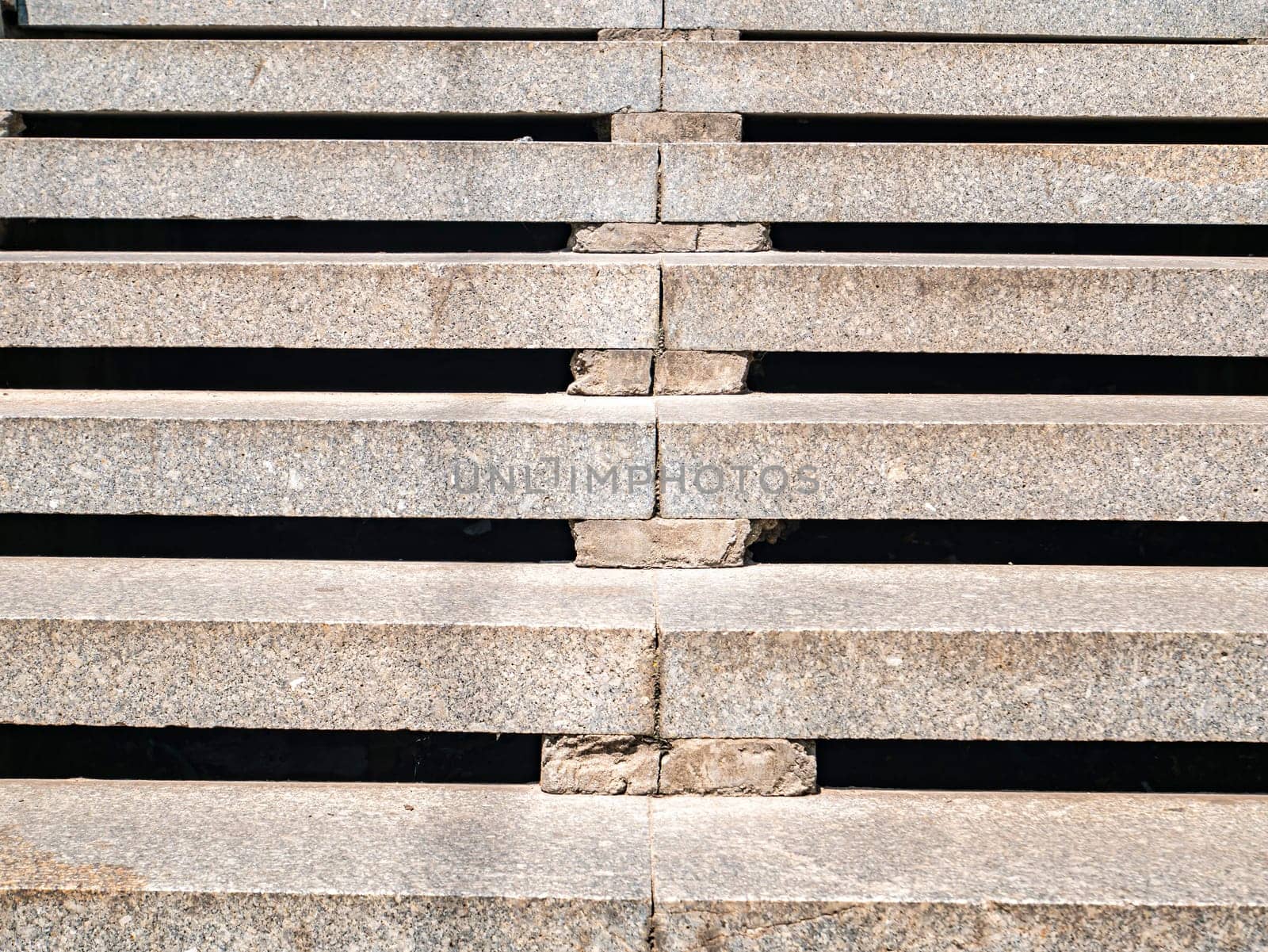 Granite steps for walking from bottom to top. Building sector. Industry. Construction and repair. Place for text. Template. Background image. Poster. Way. Career.