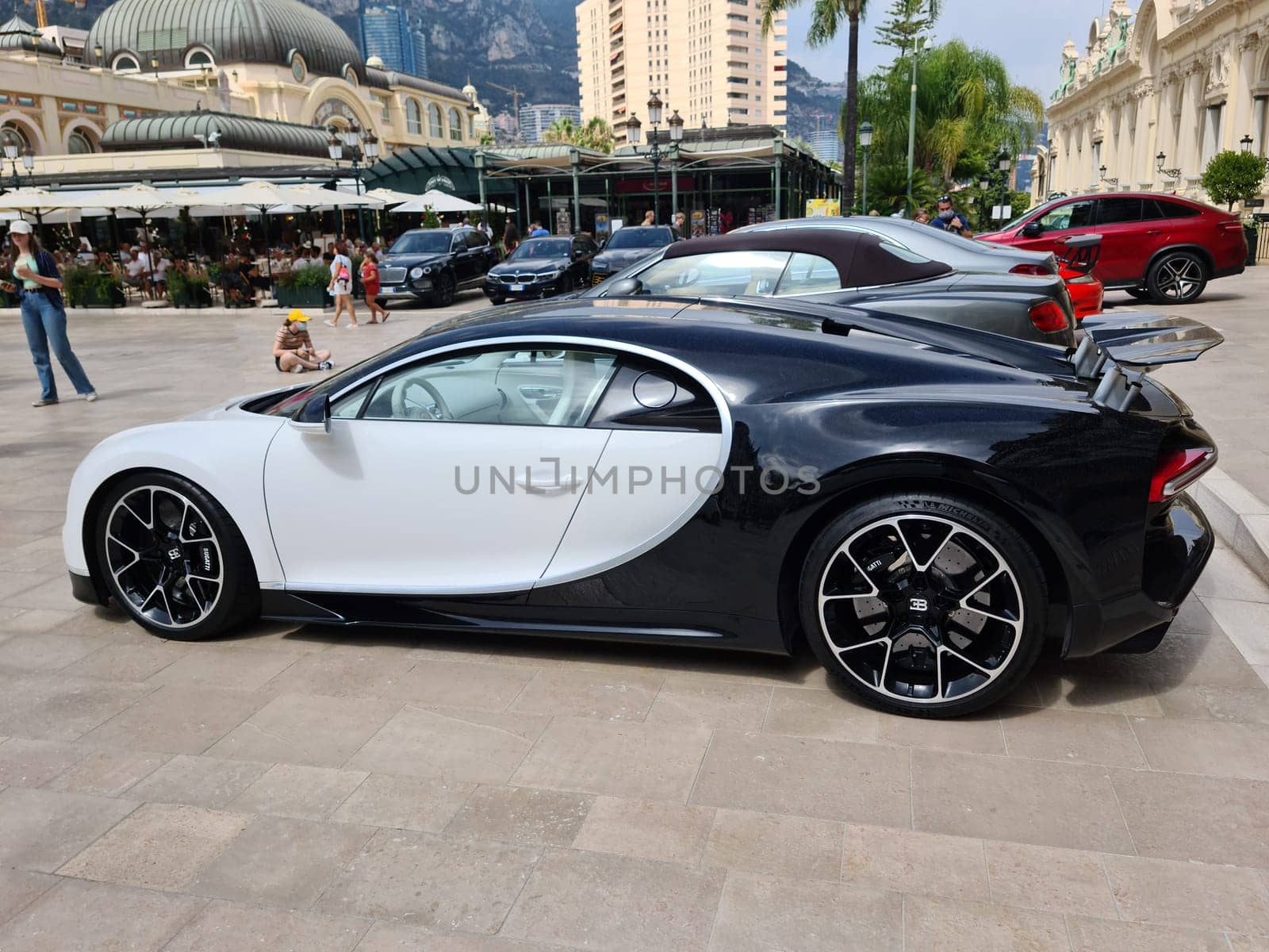 Monte-Carlo, Monaco - July 24, 2021: Beautiful White Bugatti Chiron Luxury Supercar Parked In Front Of The Monte-Carlo Casino In Monaco On The French Riviera, Europe - Side View.