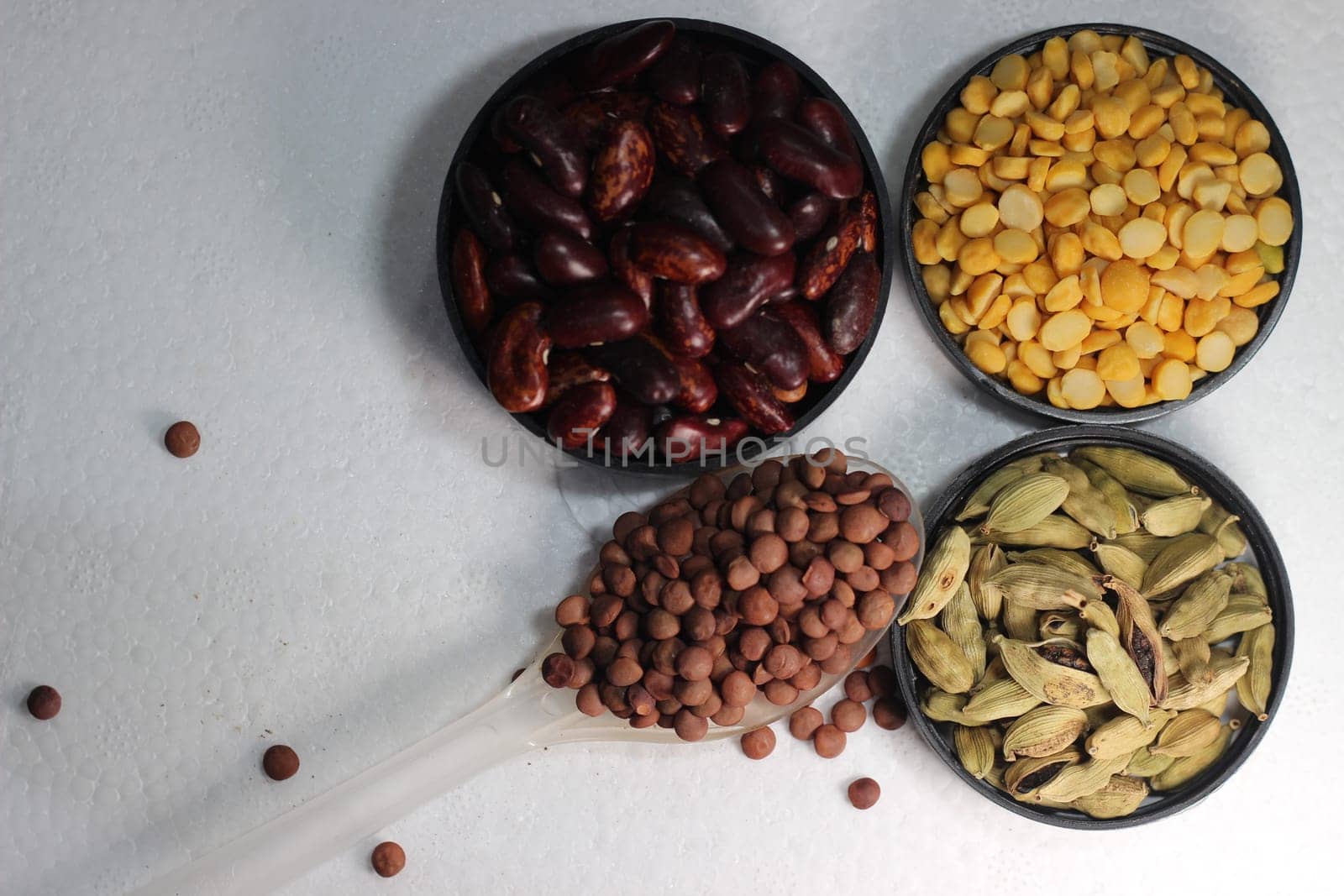 Top view of assortment of cereals, and cardamom. Collection of different spices and cereals.