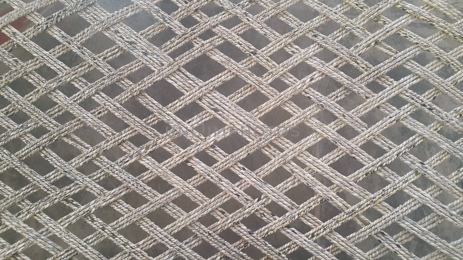Closeup view of dried jute thread or ropes interwoven for making traditional old style bed called charpai