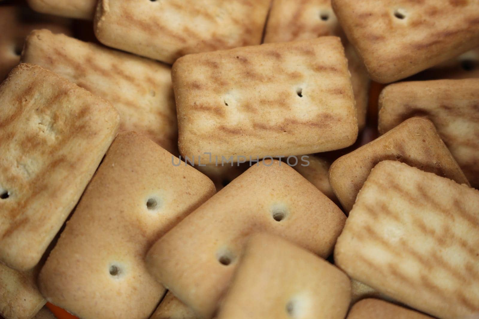 Close up top view of of biscuit cookies. Close up view rectangular biscuits with small pores