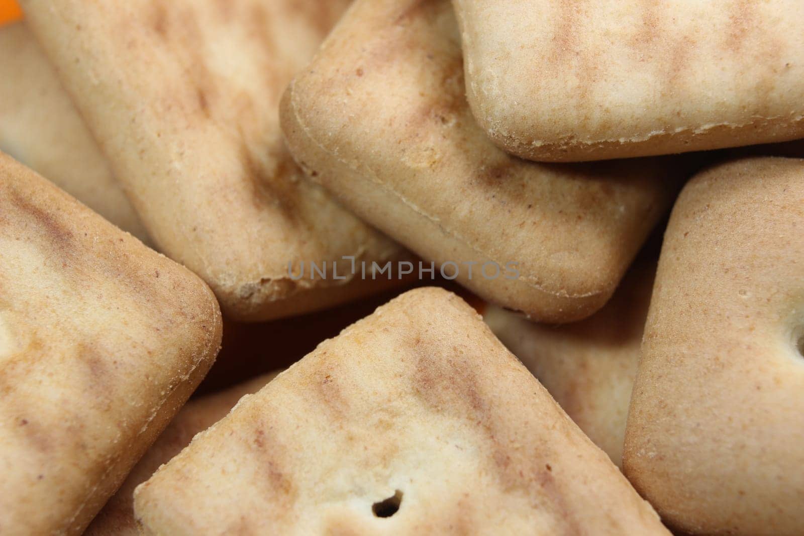Close up top view of of biscuit cookies. Close up view rectangular biscuits with small pores