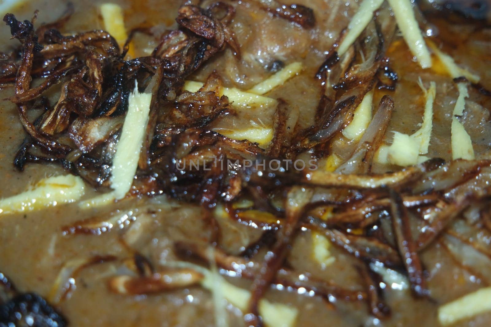 Closeup view of traditional Pakistani Haleem dish with salad and Lemon juice.