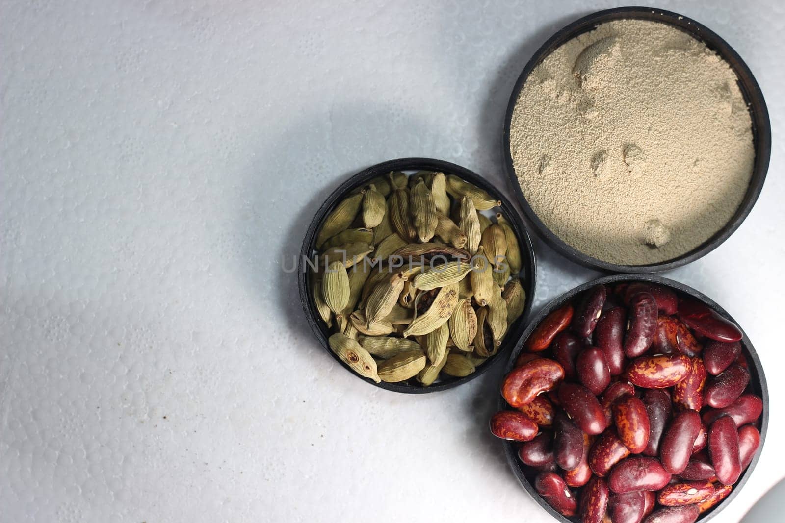 Top view of assortment of cereals, and cardamom. Collection of different spices and cereals.