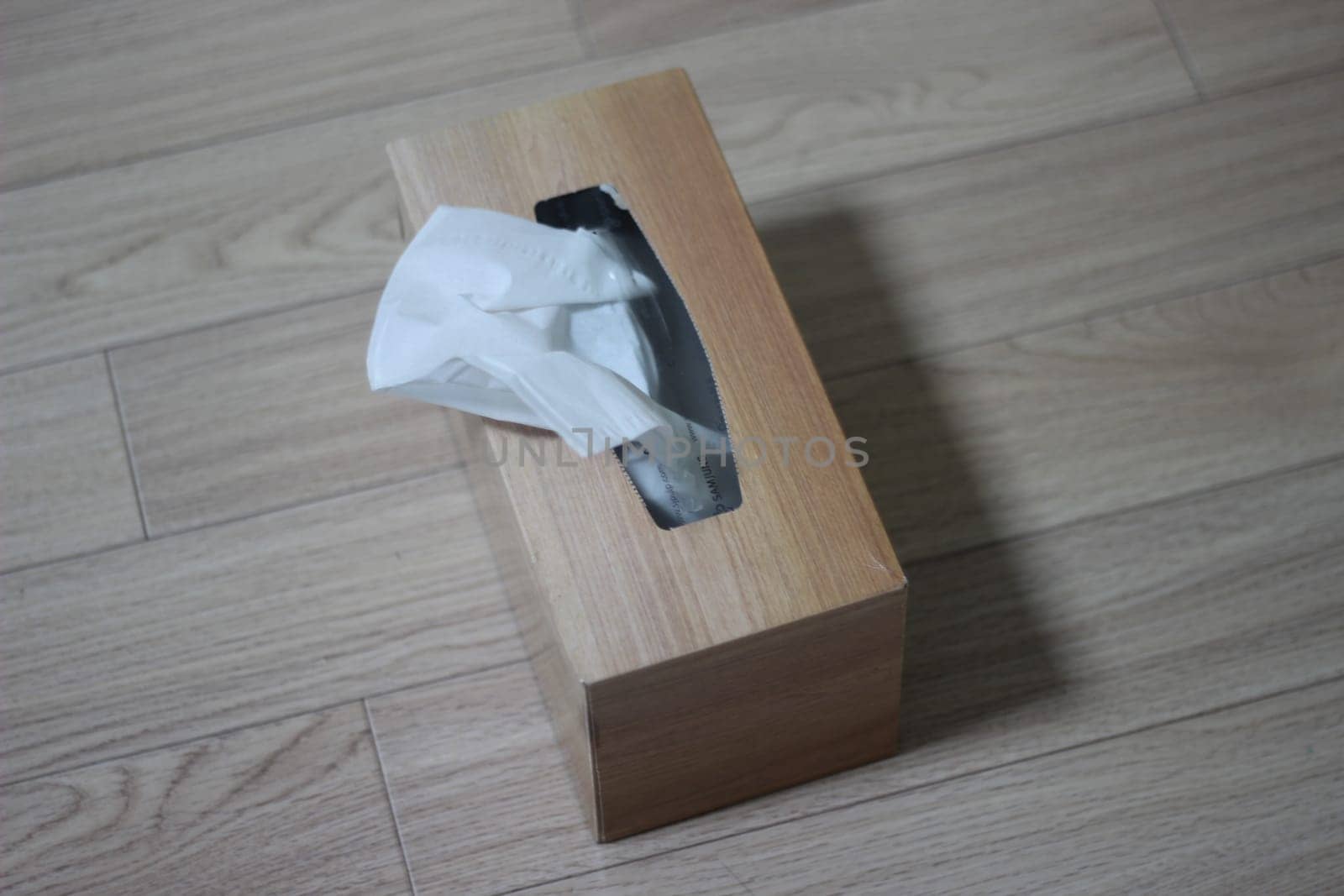 Tissue box of white facial tissue paper on wooden table