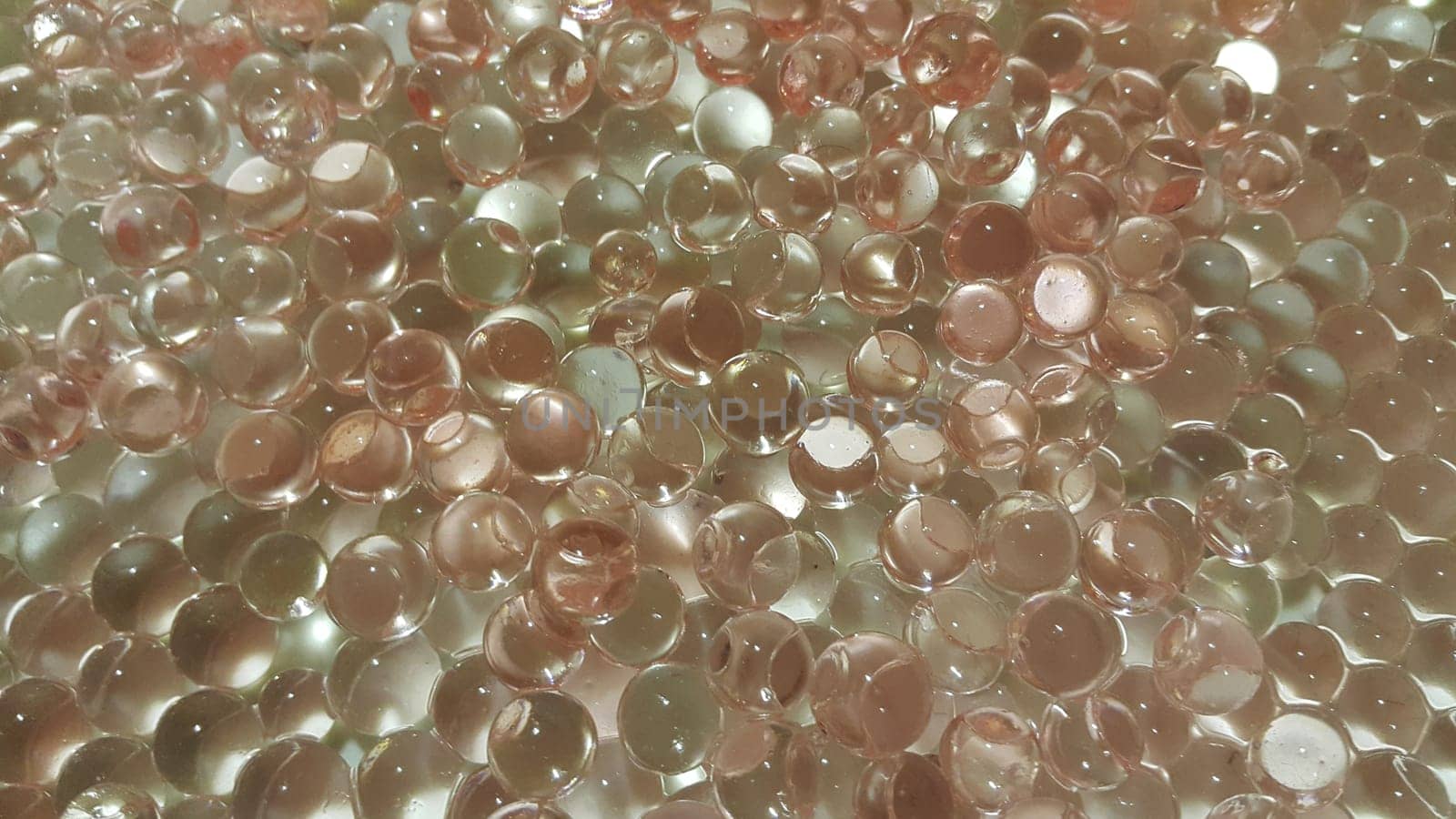 Closeup view with selective focus of shiny glittering orbeez or colorful water balls hydrogel. Water beads orbeez background.