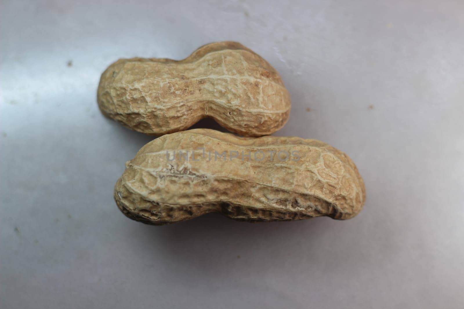 Unpeeled peanut with shells. Food background of peanuts