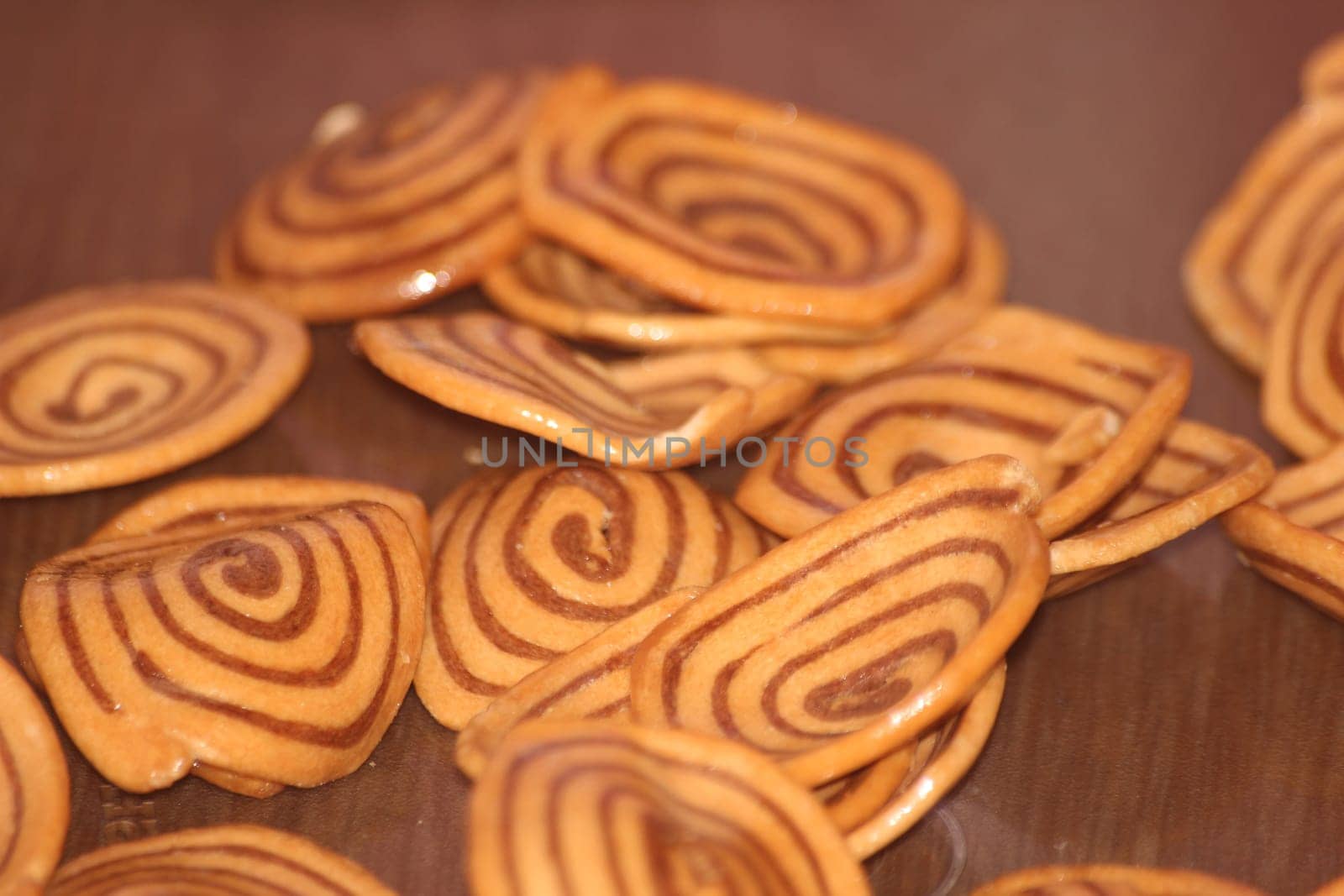 Closeup view with selective focus of a large number of round cookies with coconut filling lines.