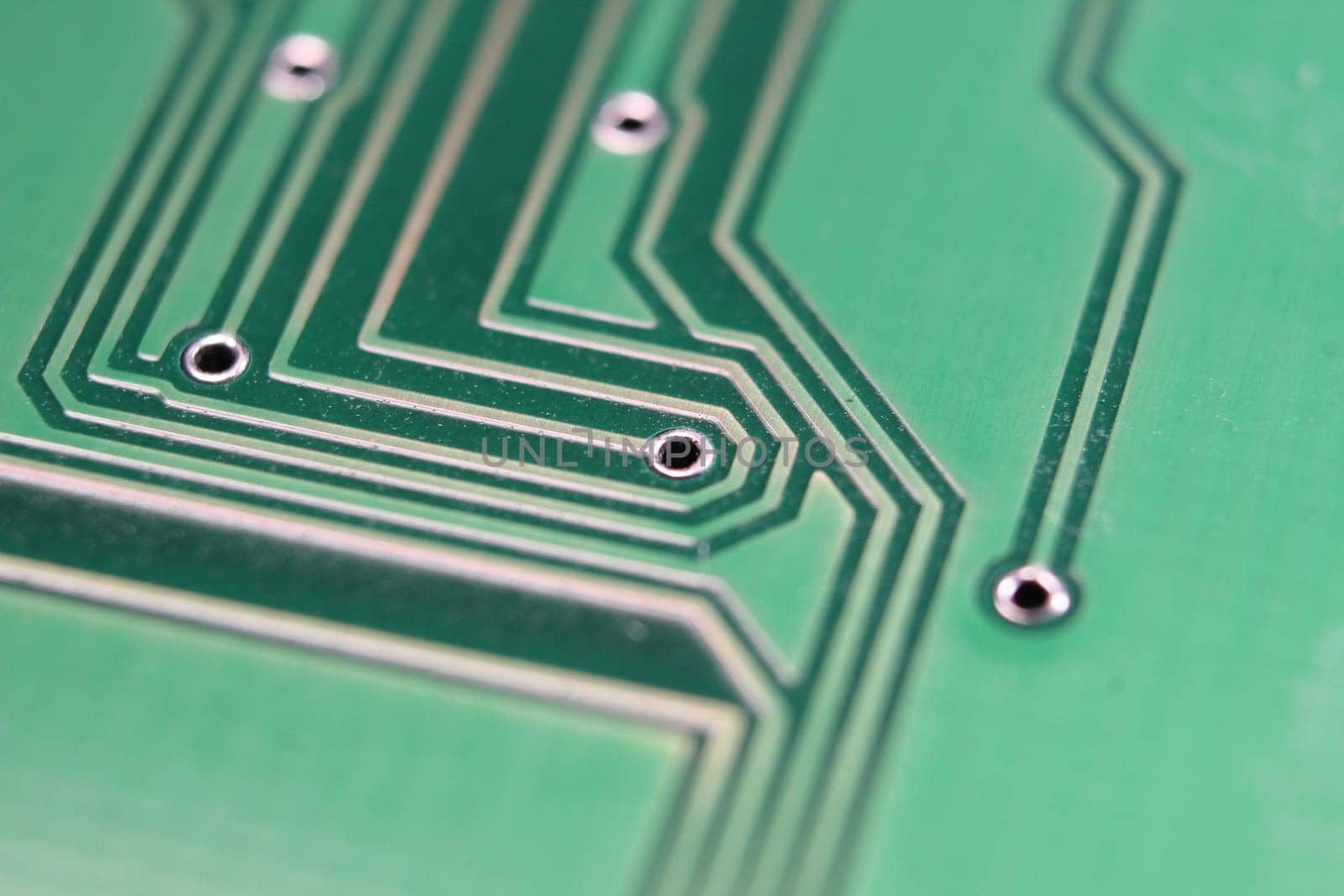 Electronic board with circuit lines and chip. Macro view of green board