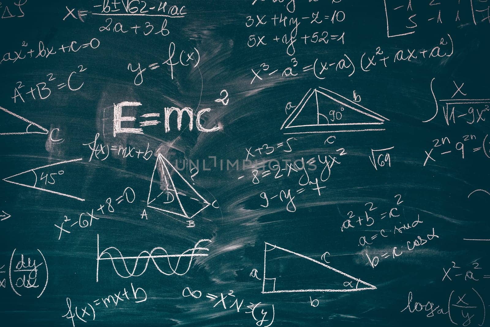 Blackboard inscribed with scientific formulas and calculations in mathematics. Science and education background.