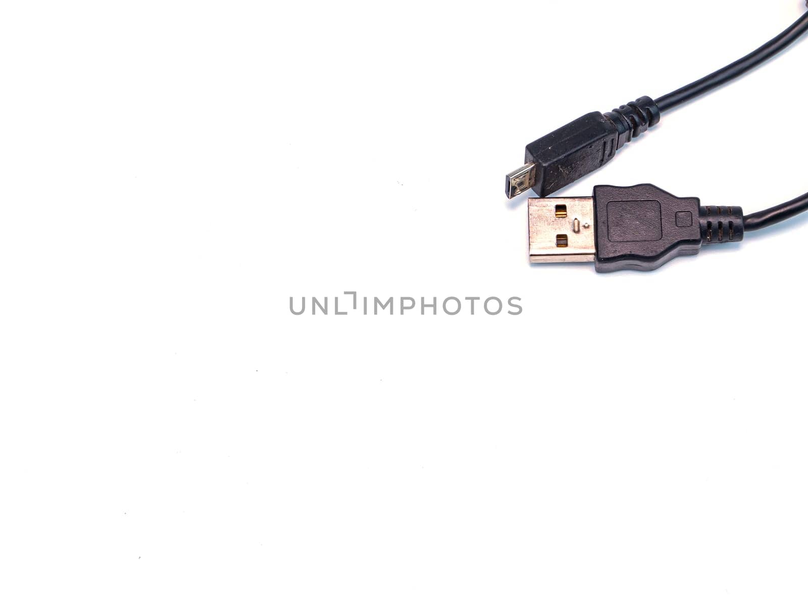 Black usb cord for transferring digital data on a white background. Digital data transmission technologies. Computer connection. Charging mobile devices. USB cord for charging the phone.