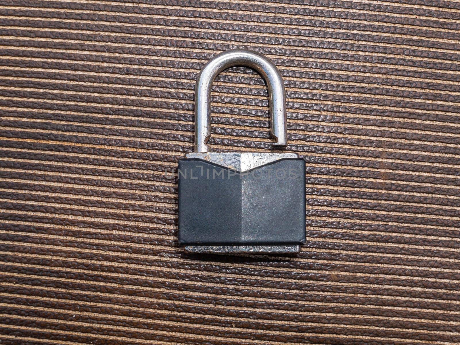 Iron padlock for locking gates and doors. Iron door padlock. Safe storage. Security of property. Protection of material assets. Metal product. Place for your text. Burglary and theft protection.