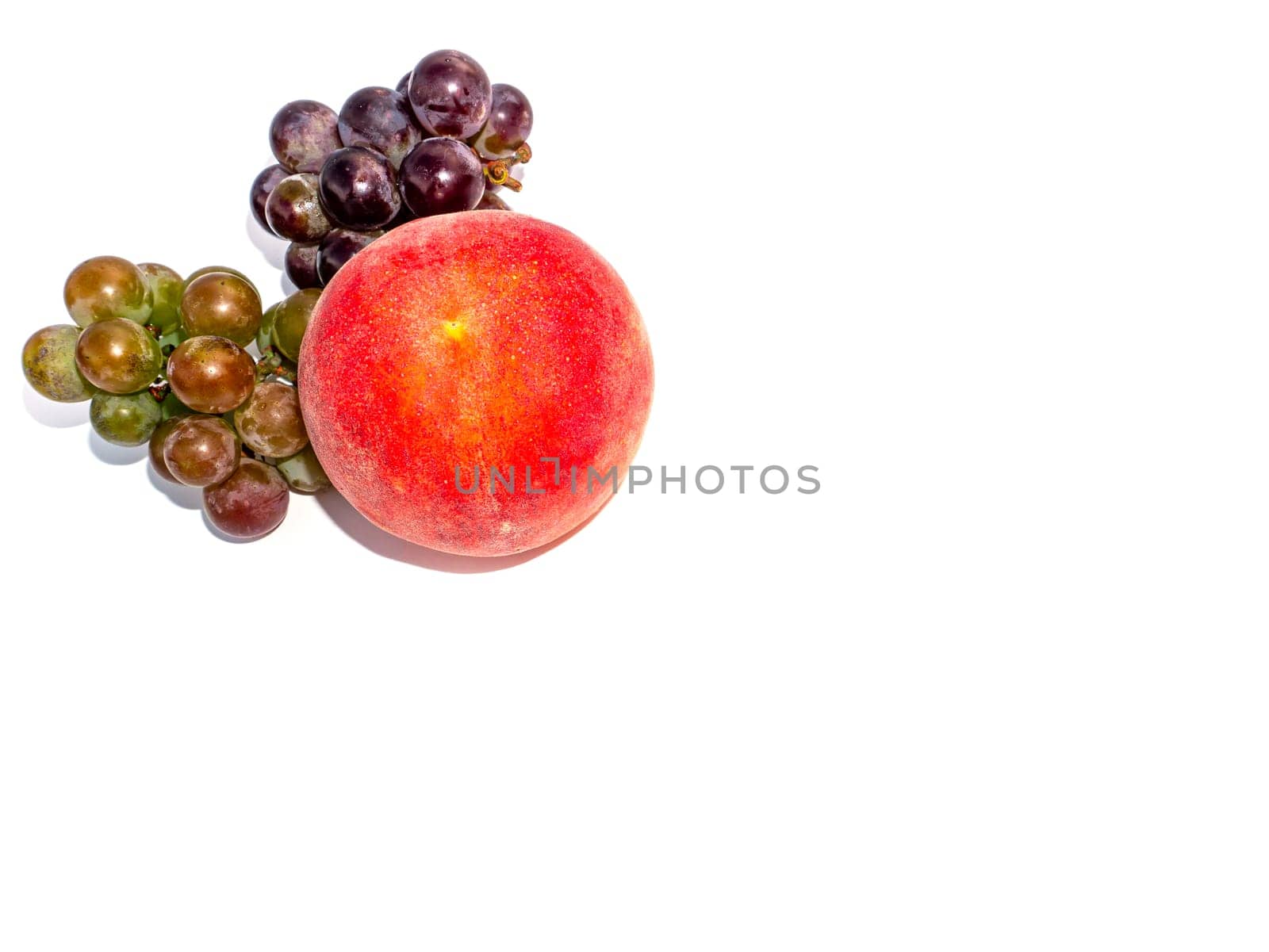 Fruit peach and grapes on a white background. Harvesting. Red peach. Bunch of grapes. Fruit juice. Food photo. Agriculture. Winemaking. Showcase of a fruit shop. Place for text. Poster.