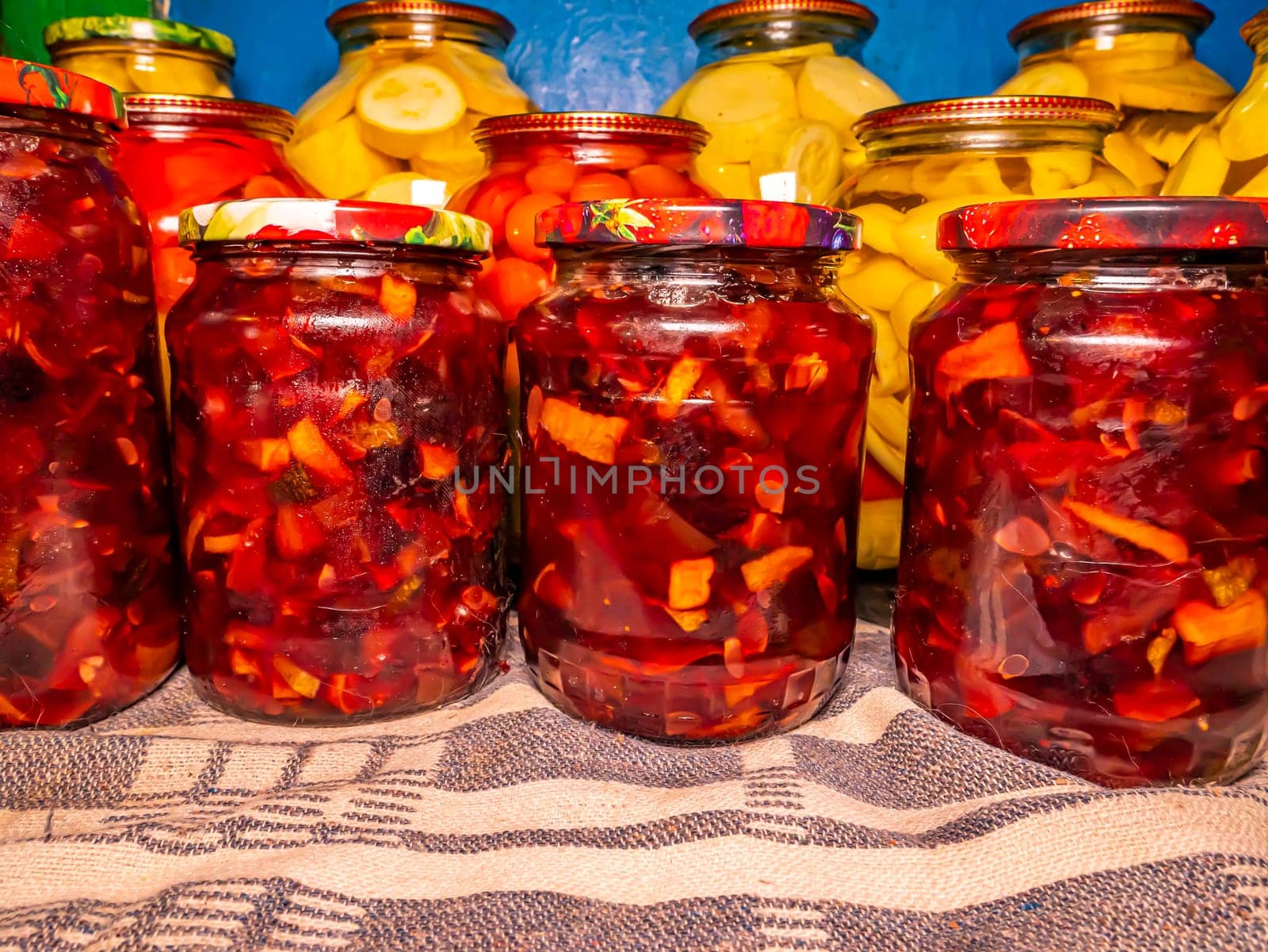 Canned fruits and vegetables in glass jars. Apple jam. Pickled vegetables. Harvest conservation for the winter. Marinate in a glass jar. Recipe. Home kitchen. Menu. Salting food. Food preparation.
