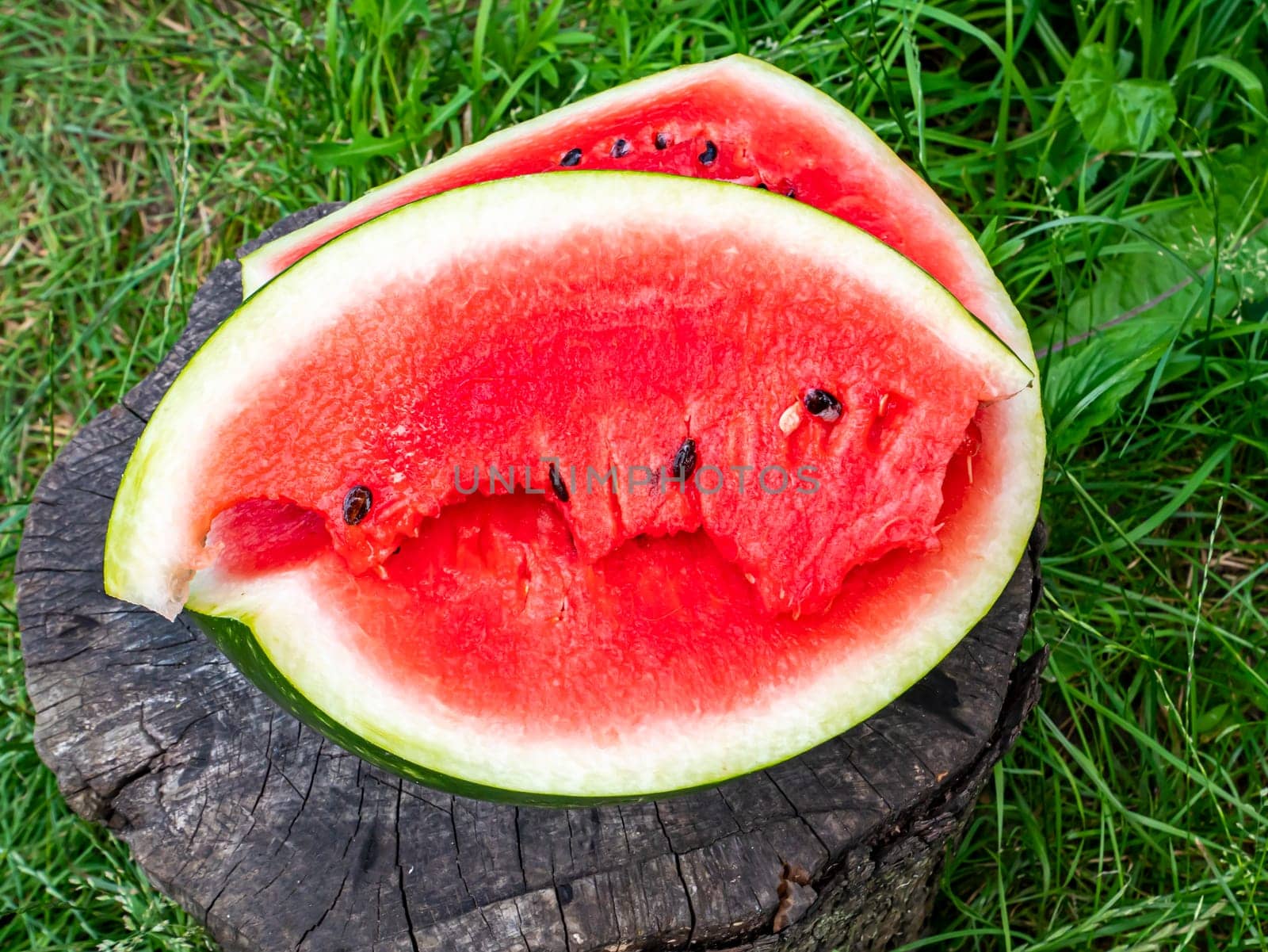 Red watermelon with seeds cut with a knife. Berry. Food photo. Place for your text. Harvest of watermelons. Background image. Poster. Advertising photo of a shop window. Summer season. Fruits.