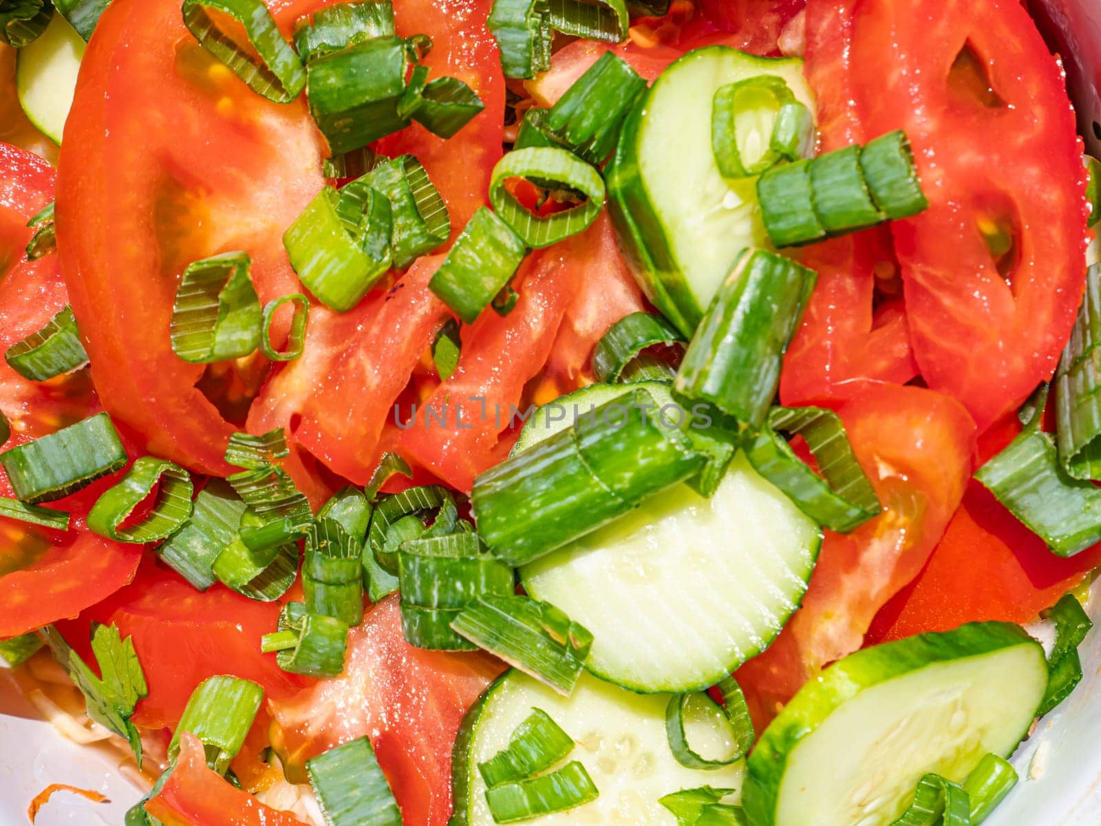 Vegetables for making fresh vegetable salad with tomatoes and cucumbers. Chives and lettuce. Cooking vegetable salad. Recipe. Home kitchen. Place for text. Shop window. Promotional photo. Menu.