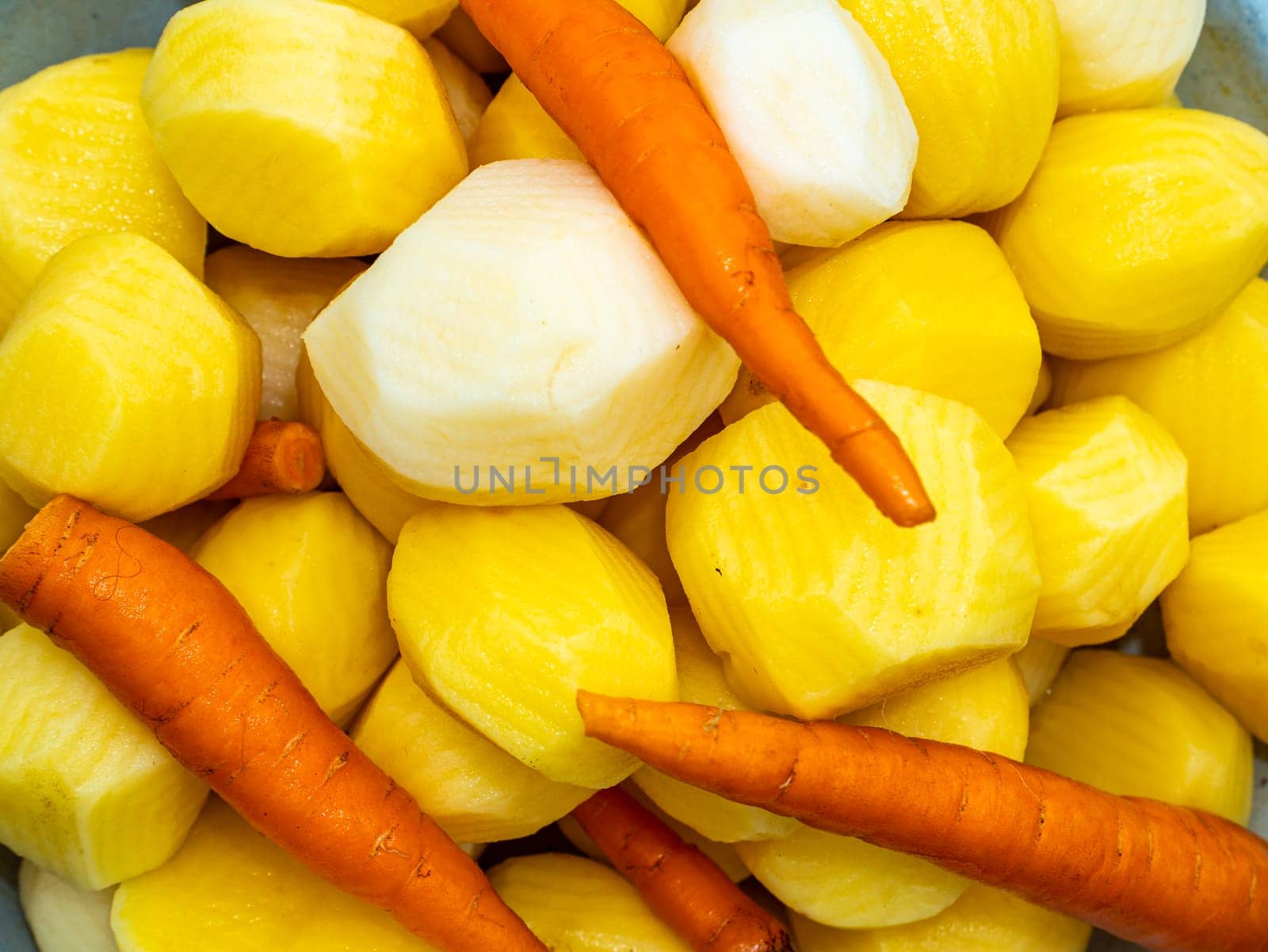 Vegetables potatoes and carrots are polished for cooking. Food photo. Harvesting vegetables. Advertising photo of a shop window of a vegetable store. Cooking food. Place for text. Background. Menu.