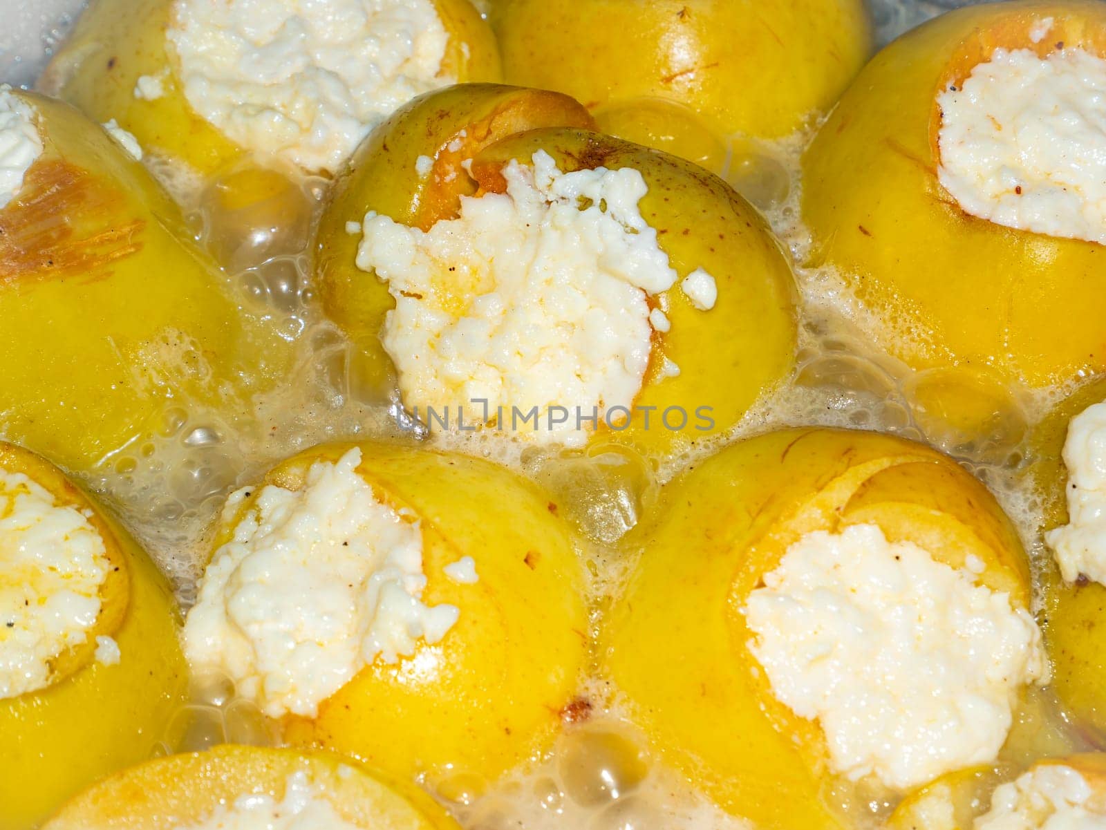 Baked apples stuffed with cottage cheese in a pan. Food photo. Sweet food menu. Dessert. Cooking food. Home kitchen. Showcase advertising photo. Place for text. Background image.