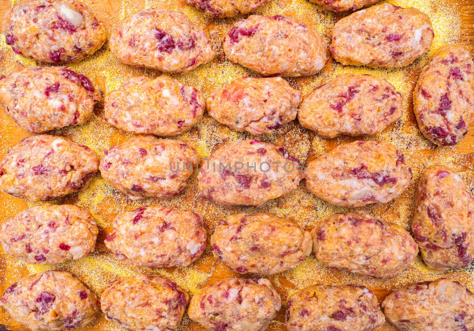 Raw meat cutlets on a wooden cutting board. Food photo. Meat dish. Preparing food. Home kitchen. Recipe. Raw minced meat. Chicken's meat. Cutlets. Cook. Advertising photo of the shop window ..