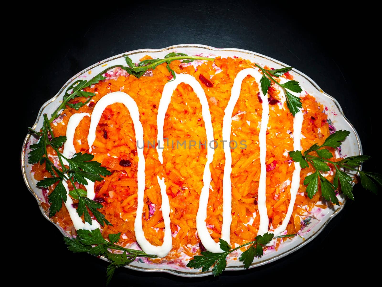 Vegetable salad with carrots decorated with parsley. Food photo. Menu of dishes. Recipe. Cooking food. Home kitchen. Vegetarianism. Healthy lifestyle. Place for your text. Template.