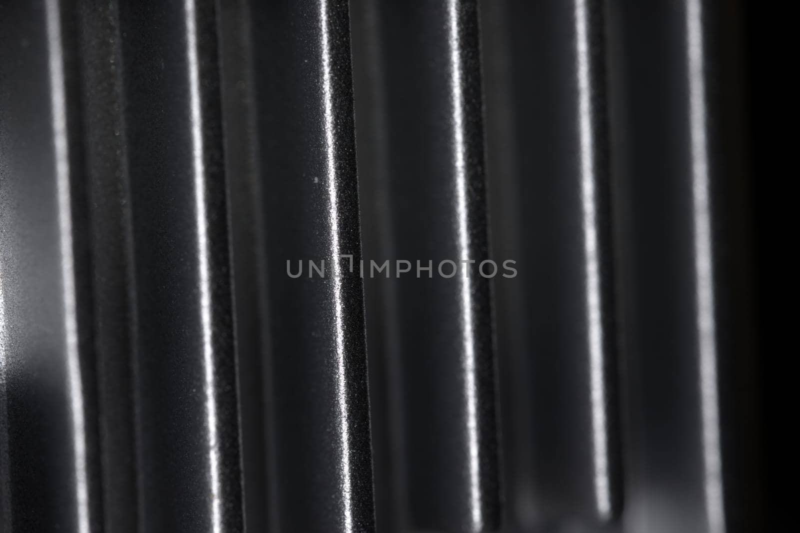 Abstract metal texture detail from the cooling fins of a drone gimbal heat sink. Aluminum or aluminium in material. Full frame abstract background.
