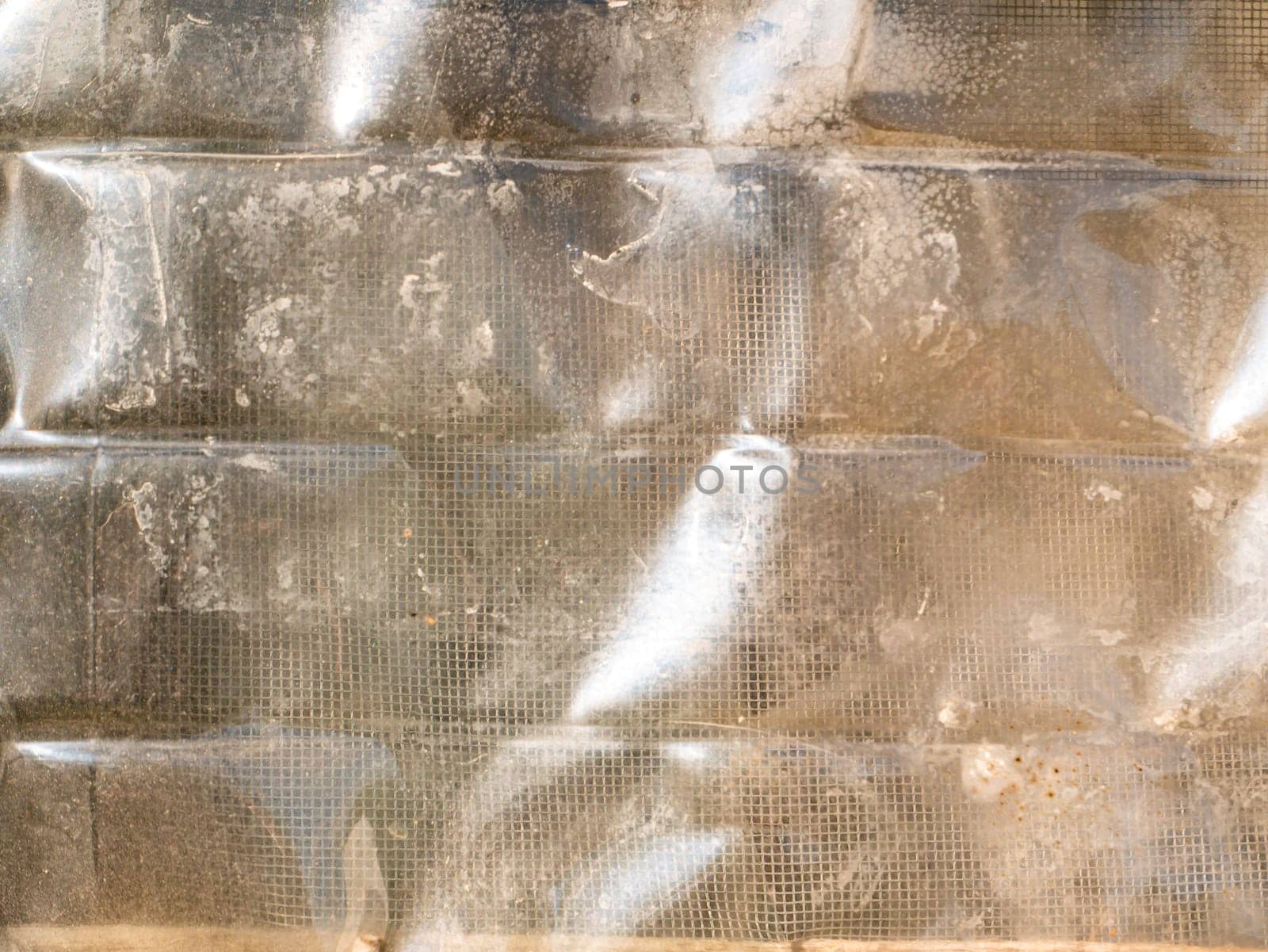 The texture of the transparent surface of the plastic container. Polyethylene texture. Plastic bottles. Dishes. Household polyethylene waste. Ecology. Environmental pollution. Background image.