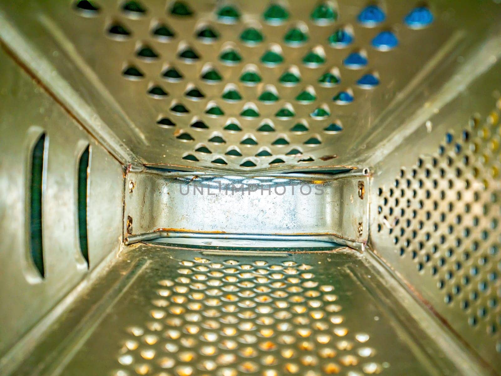 Kitchen tool aluminum hand grater inside view. Manual kitchen tools. Grater for chopping vegetables and fruits. Cooking food. Chef's job. Culinary specialist. Background image. Place for text.